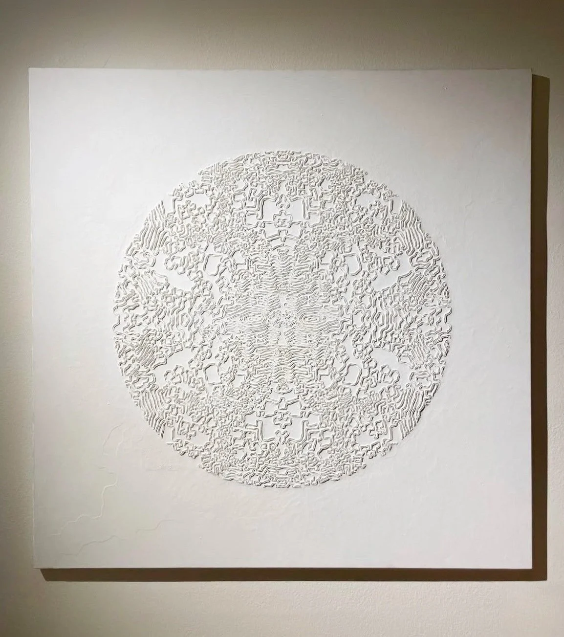 Textured circular abstract relief featuring fine carved patterns, ideal for contemporary interior design.