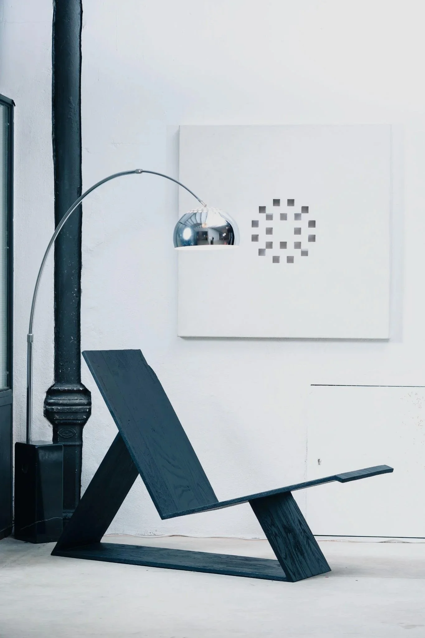 White geometric wall art featuring carved square openings that create an optical illusion in changing light.