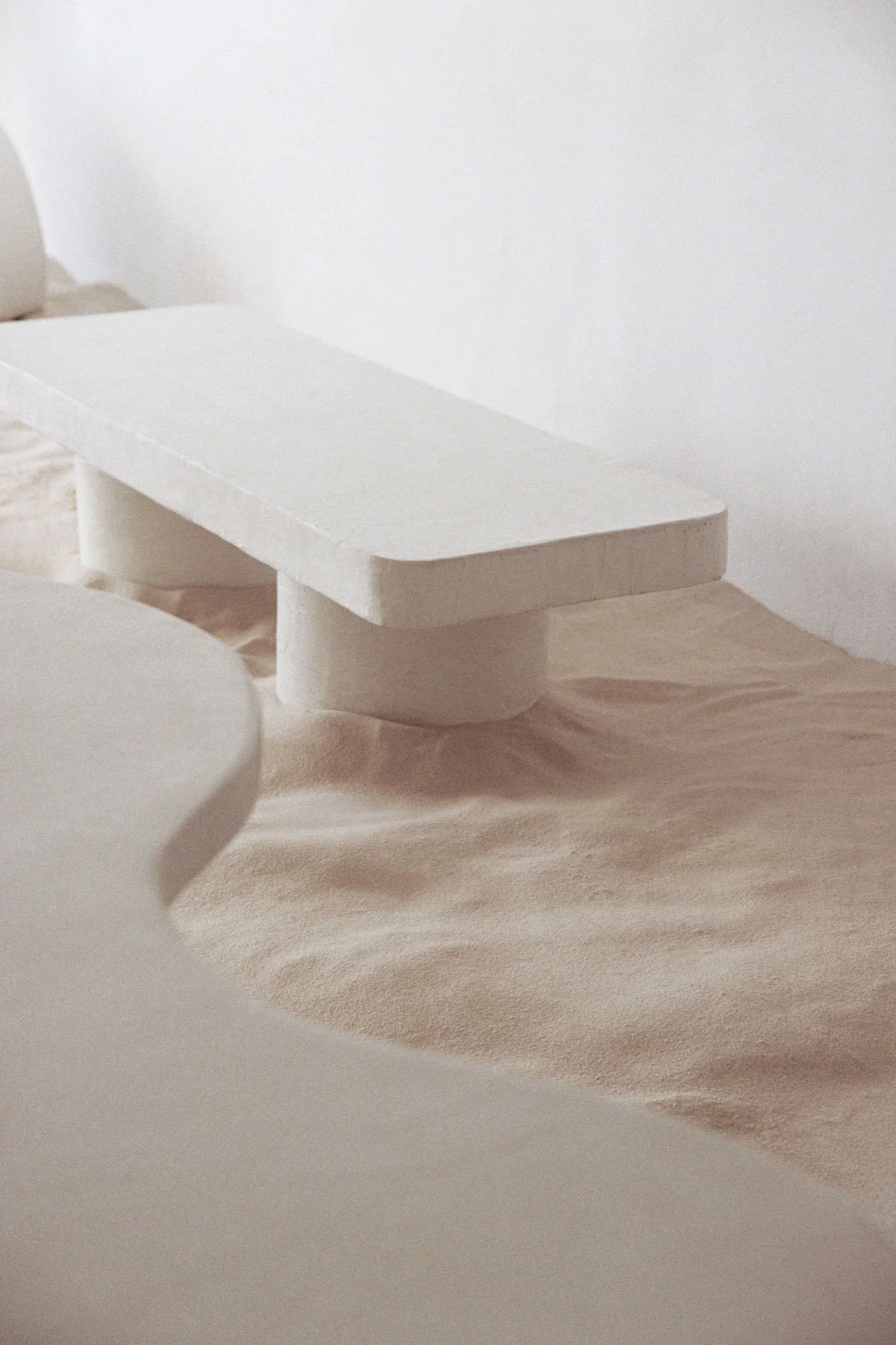 Organic sculptural furniture crafted in microcement for gallery-like and curated interiors