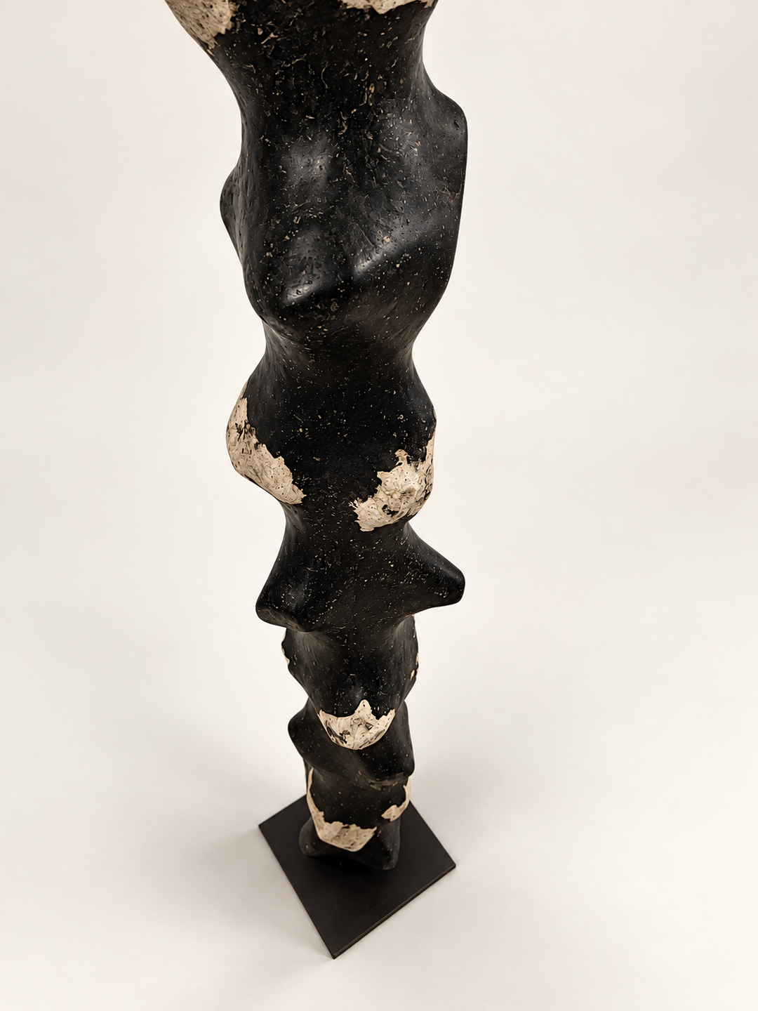 High-angle view of Tótem III, collectible design sculpture by Justino Del Casar in speckled black paper