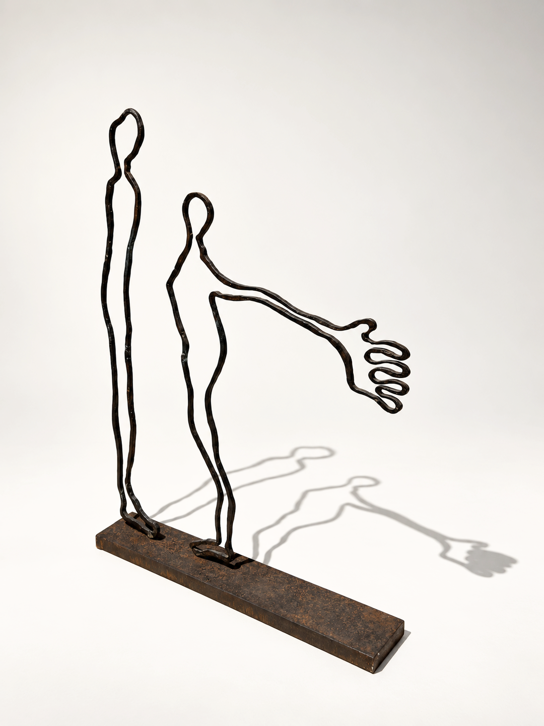 Contact bronze sculpture by Robert Pous casting figurative shadows, contemporary art at BLANCONEGRO BARCELONA