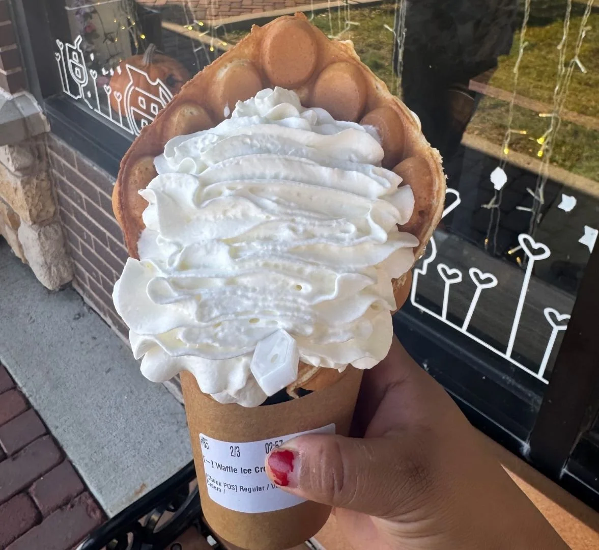Coco Rolls Egg Waffle Cone Vanilla Ice Cream Held by Hand