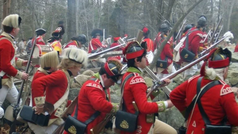 A reenactment of a battle during the American Revolutionary War.