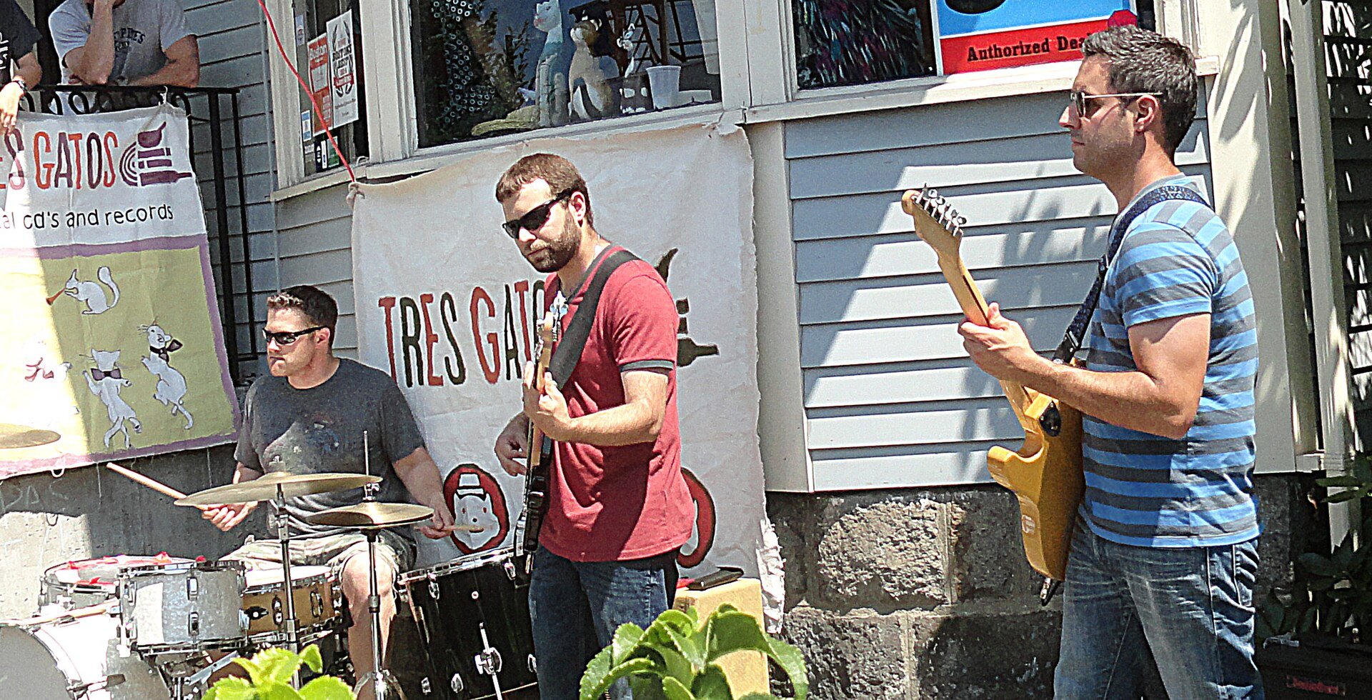 Three-piece band playing music outside 