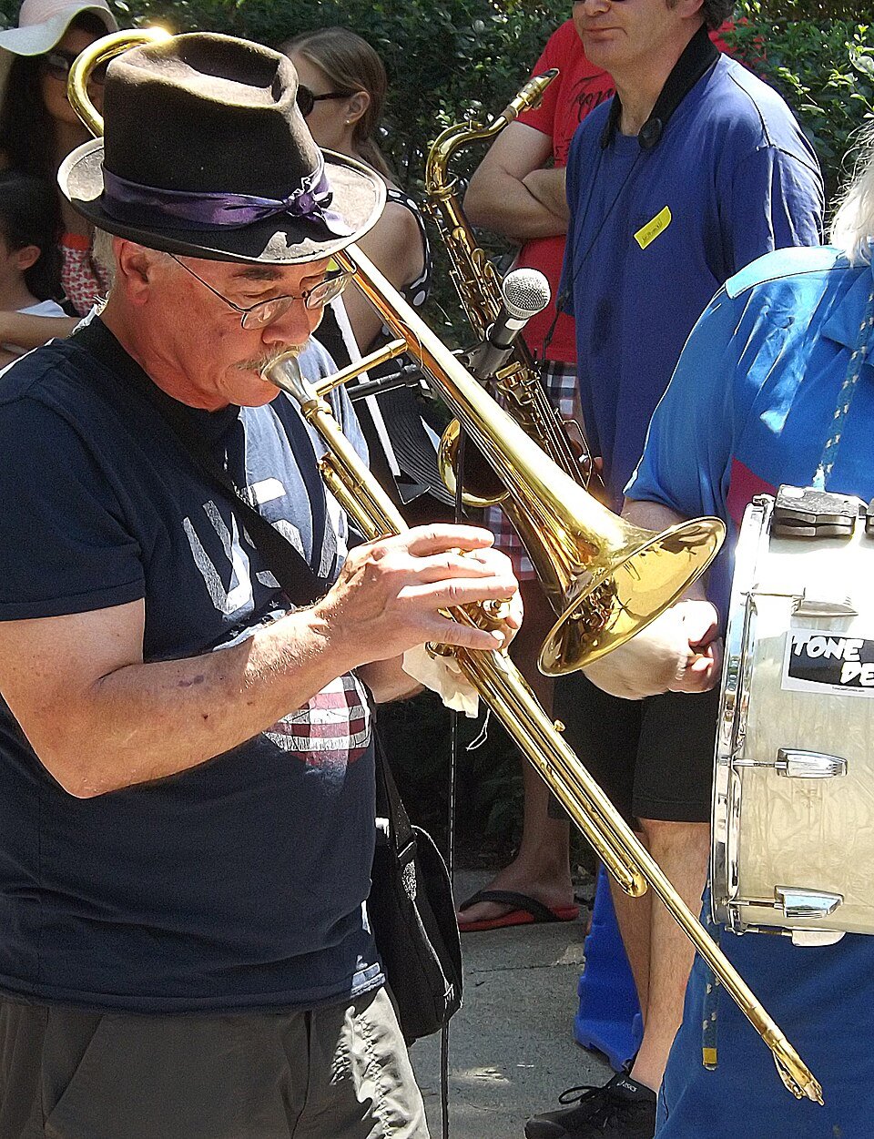 Individual playing a trombone at Somervile Porchfest