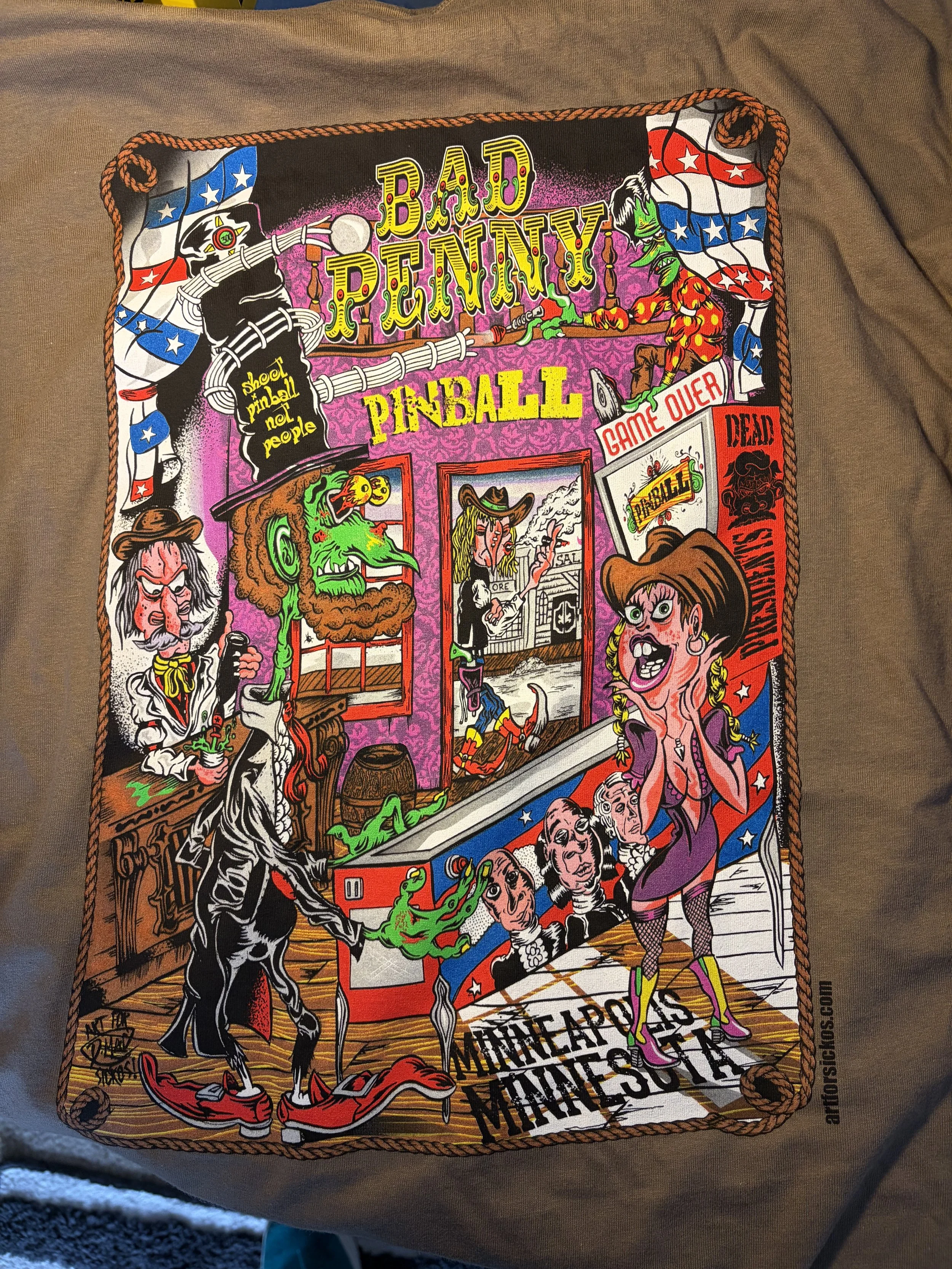 T-shirt graphic with Abraham Lincoln playing a pinball machine that says Shoot Pinball Not People