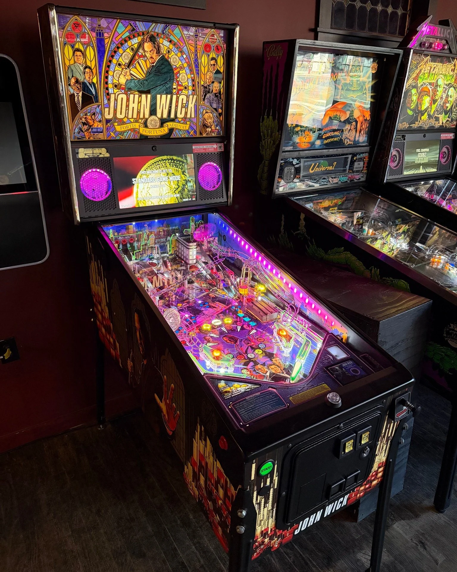 John Wick LE is at Mort's! Recently updated with the 1.0 code, this game is nearing manufacturer completion.

Released in May 2024 and capped at 1000 units, it continues the story of Baba Yaga in a world under glass. Open the trunk full of gold coins