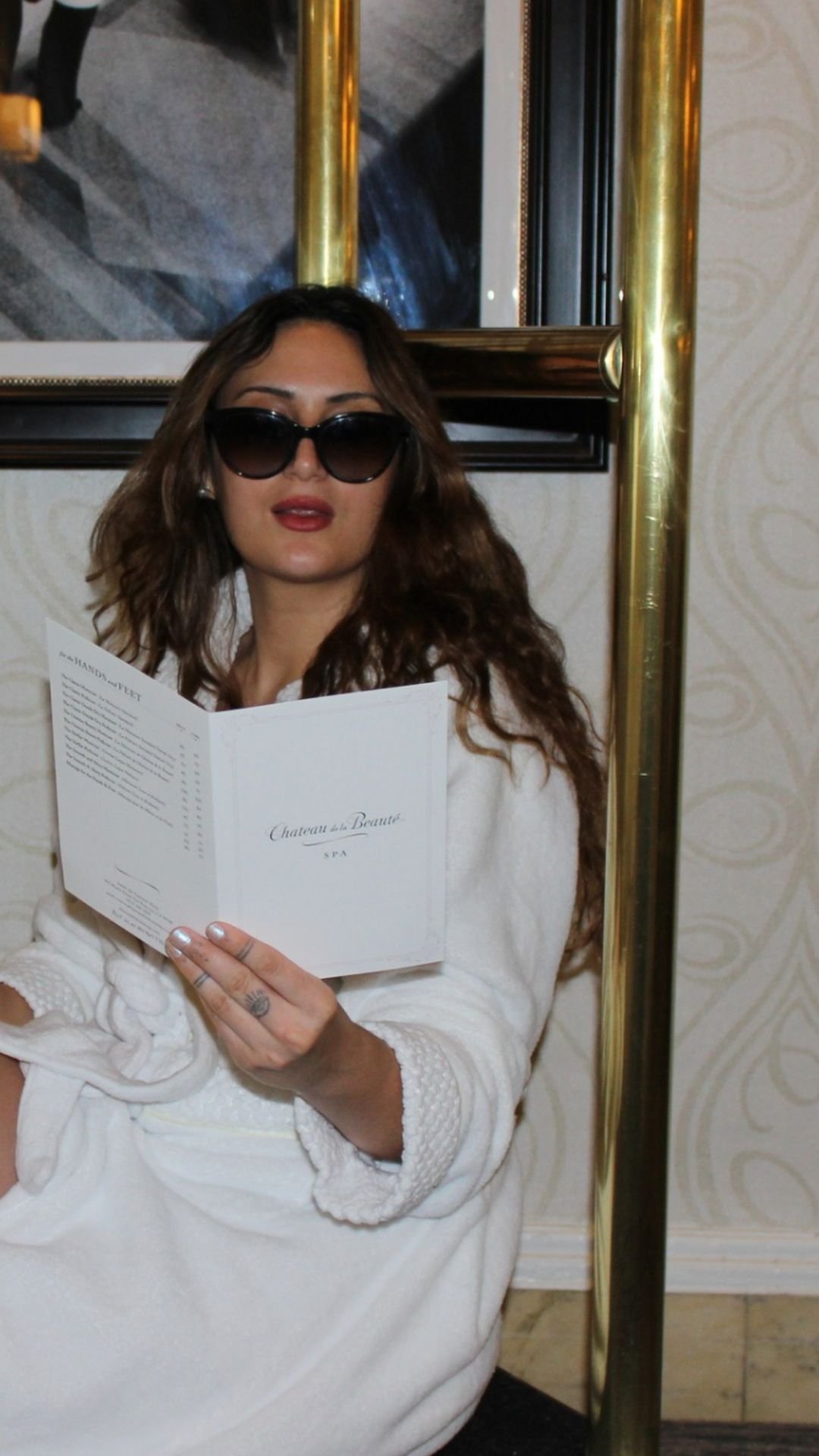 Skylar reads the Chateau de la Beauté spa menu on a sleek trolley at the Fairmont San Francisco, preparing for a luxurious day of facial and wellness treatments