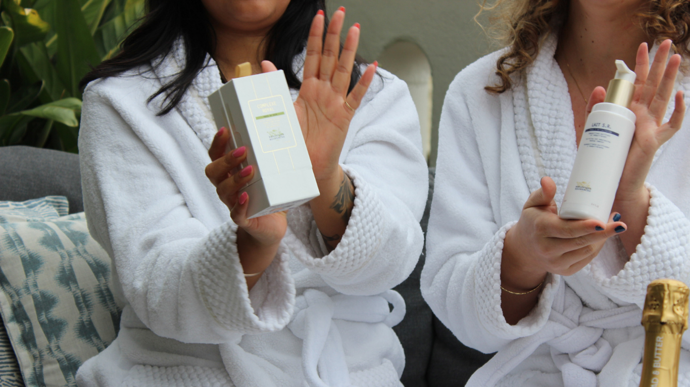 Two girlfriends proudly display their Biologique Recherche skincare products after luxurious facials in San Francisco.