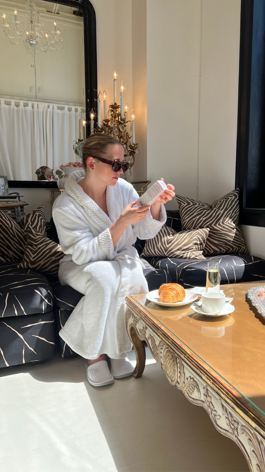 Martha reviews her personalized MBR Skincare recommendations in the spa lounge after a facial treatment, enjoying a fresh croissant