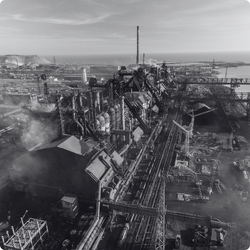 Industrial facility with pipes, tanks, and structures in an industrial setting.