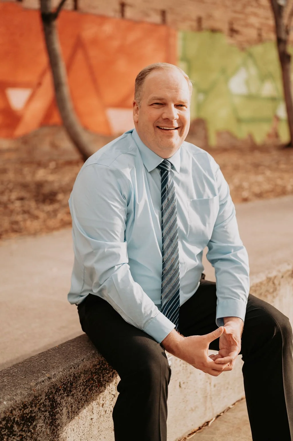 Logo for Nebraska Peace of Mind Behavioral Health, featuring a stylized face outline within a circular shape with a leaf on top.