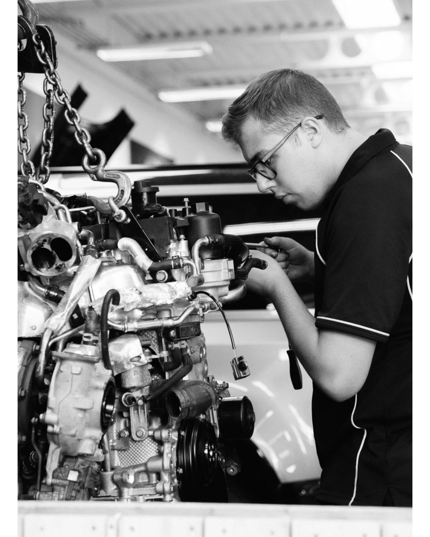 Technician carefully working on an engine