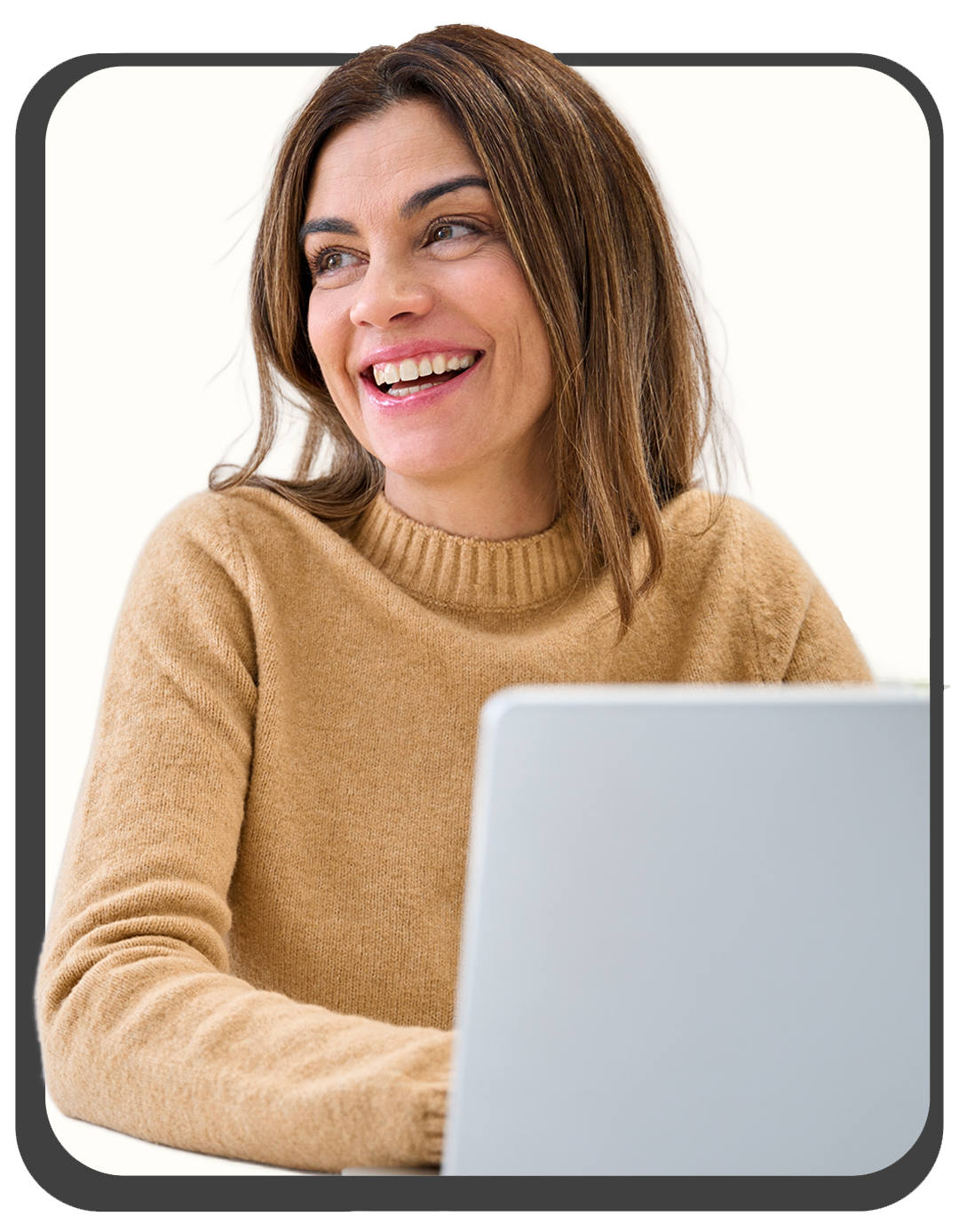 Woman smiling while looking at her laptop