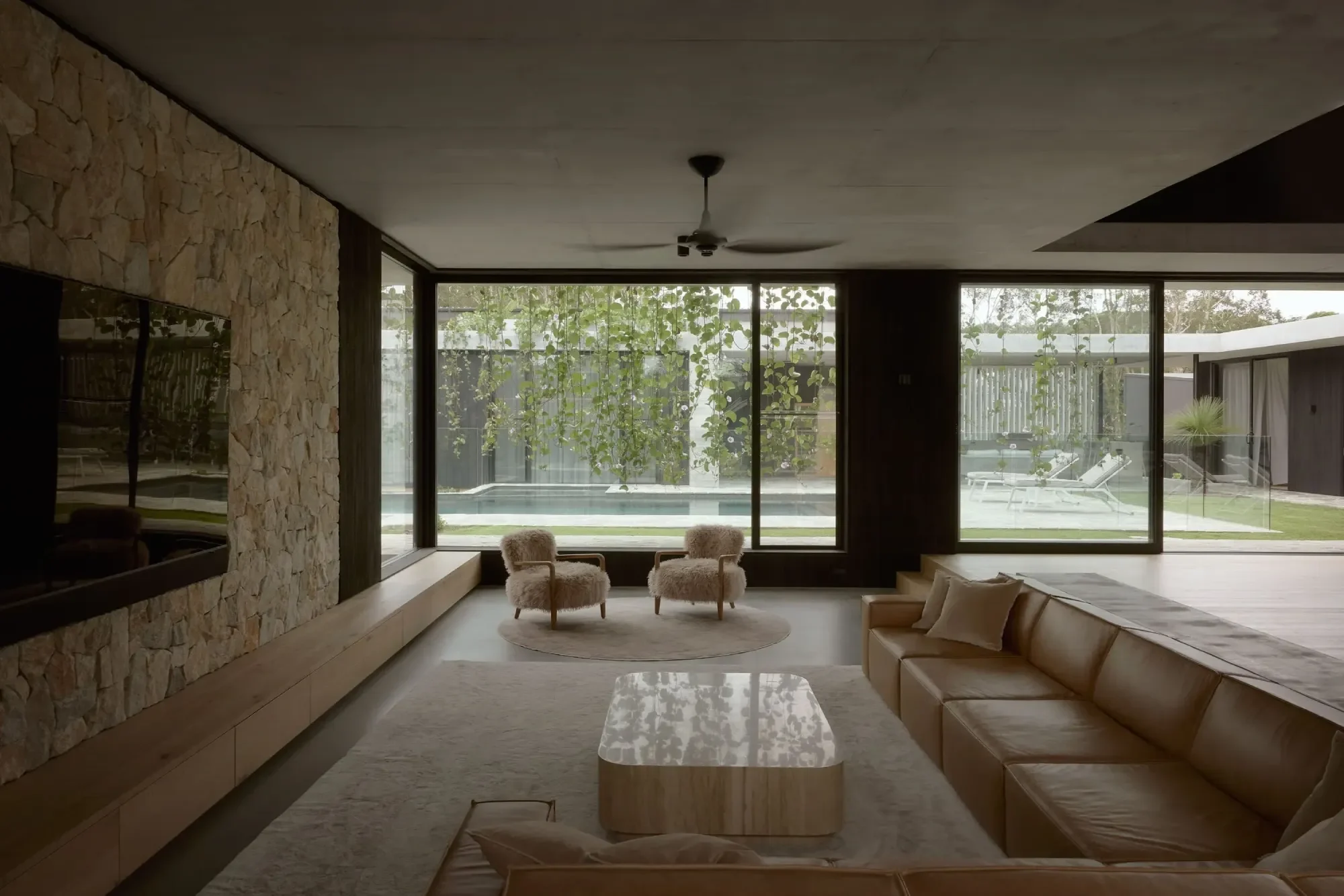 Open plan living with floor-to-ceiling glazing overlooking native bushland, residential architect Sunshine Coast