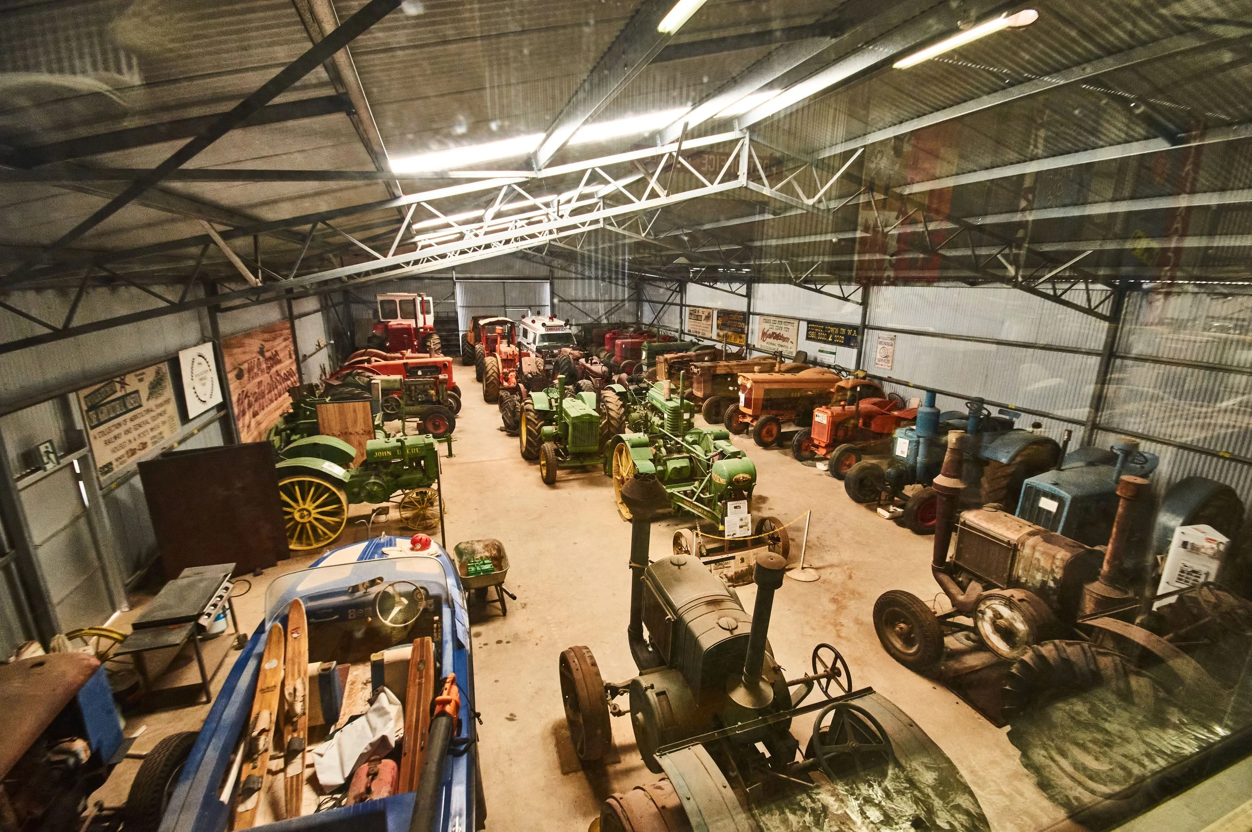 Kevin's shed, Indoor display of vintage tractors in a barn-like structure with metal walls and roof