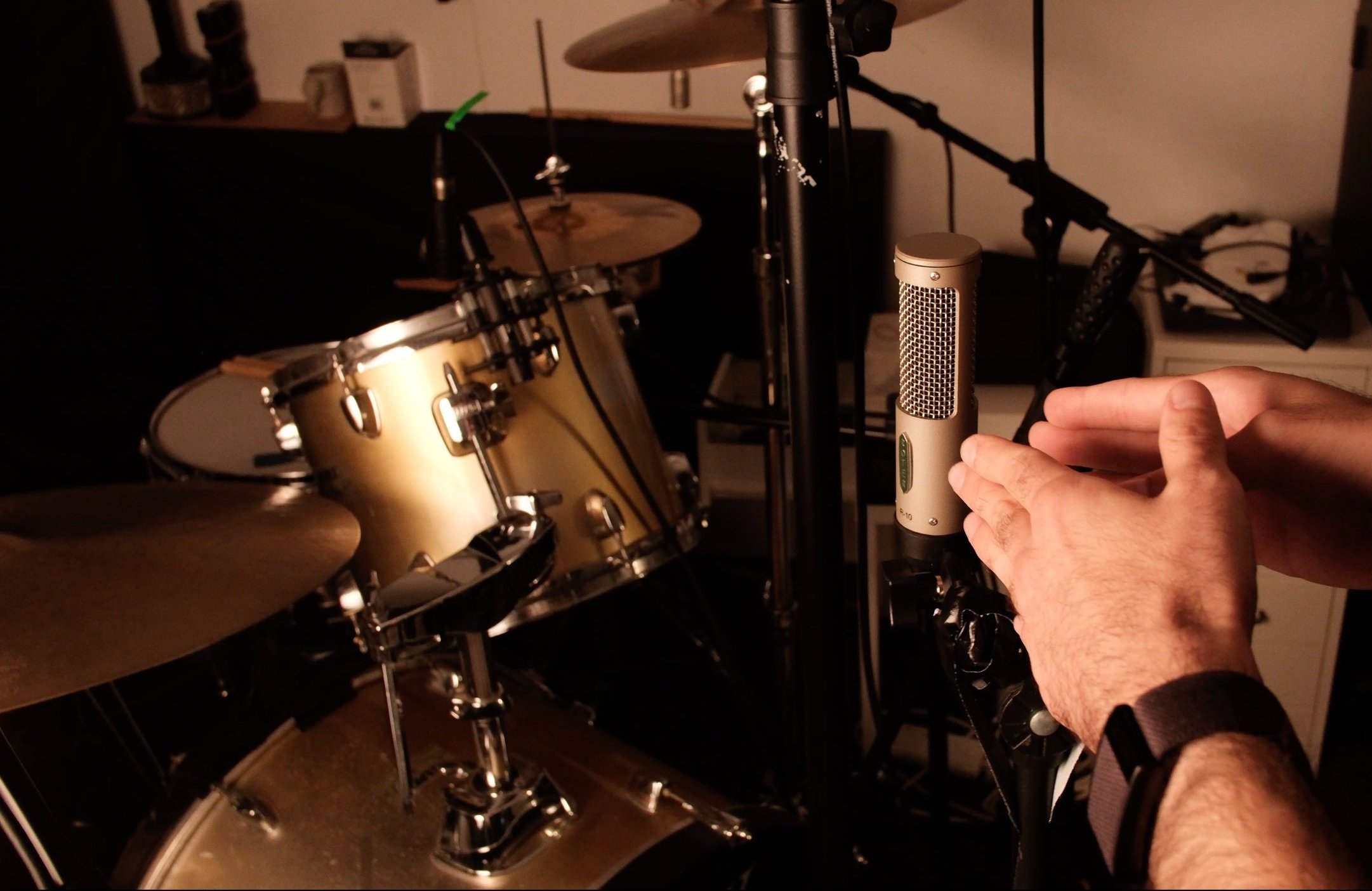 Front of the kit: Royer R10 - same distance from the snare as overheads, figure 8 pattern picking up the sides of the kit / reflections from the walls