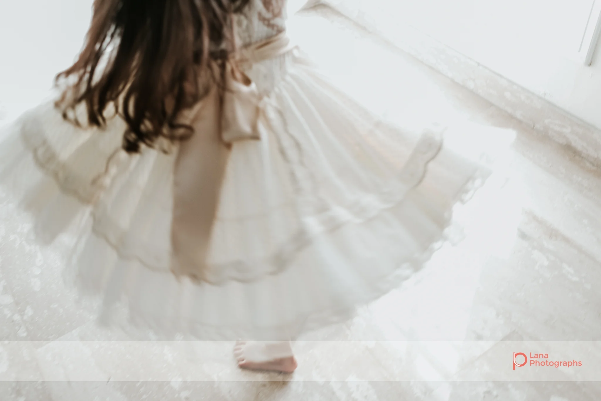 Lana Photographs Family Photographer Dubai Top Family Photographers portrait of little girl twirling