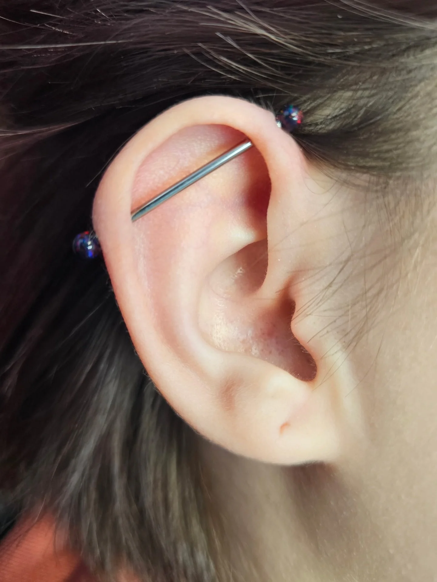 An industrial Courtney pierced a while ago who came in to be downsized. Her client chose these beautiful dark multicolored synthetic opals for her ends. 

@piercingsbycourtney

To schedule a piercing, change out, or to purchase jewelry, text the stud