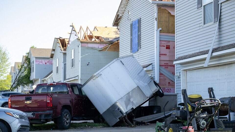 Knocked over tractor trailer and townhomes with siding blown off