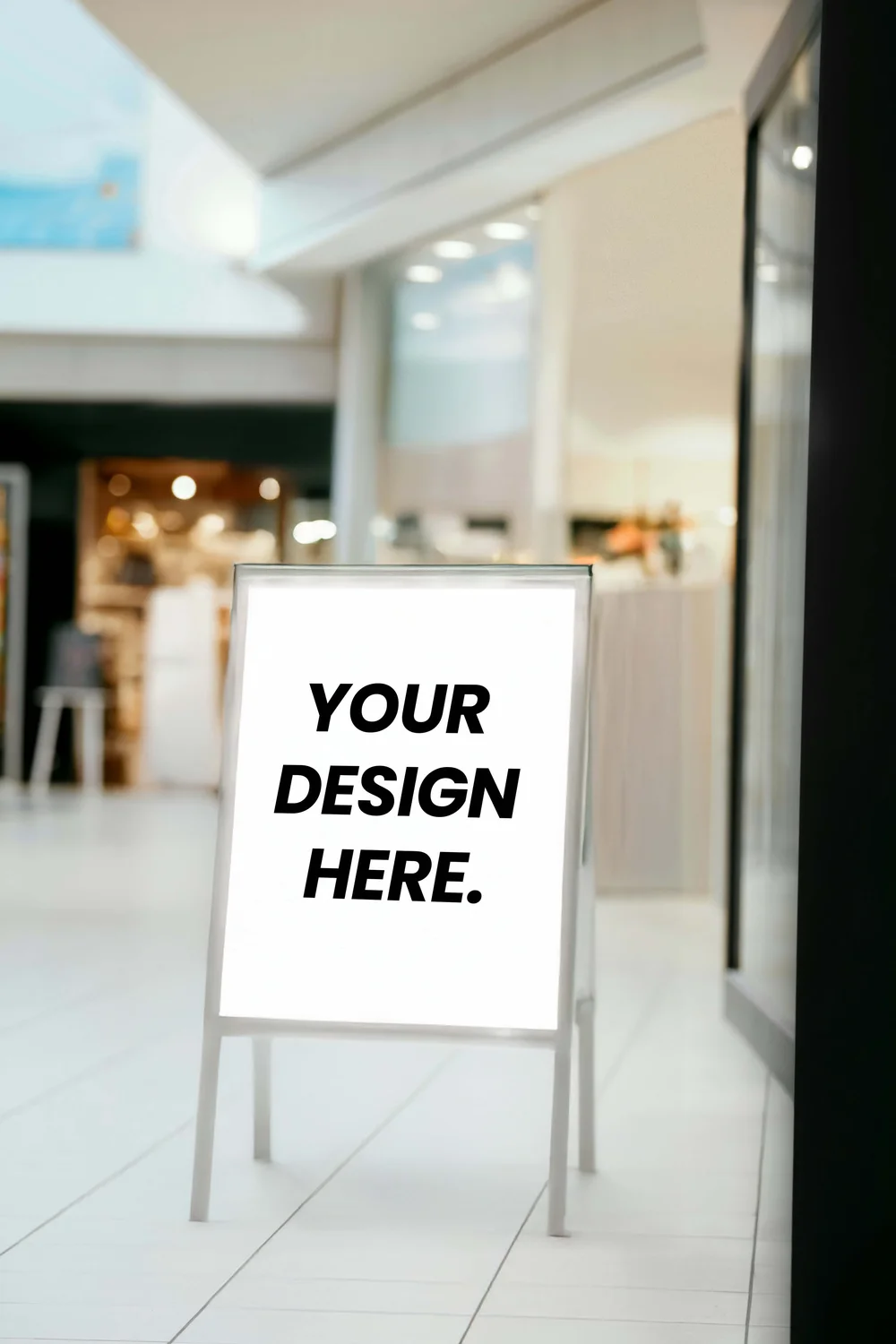 White A frame sign reading Your Design Here standing on a floor