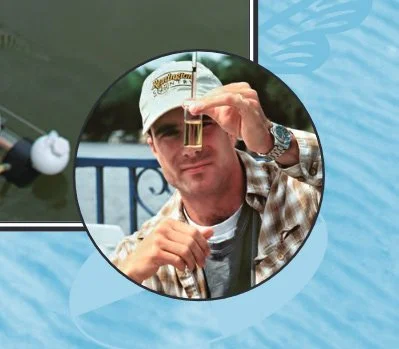 Man in a cap examining a test tube outdoors with a blurred background.