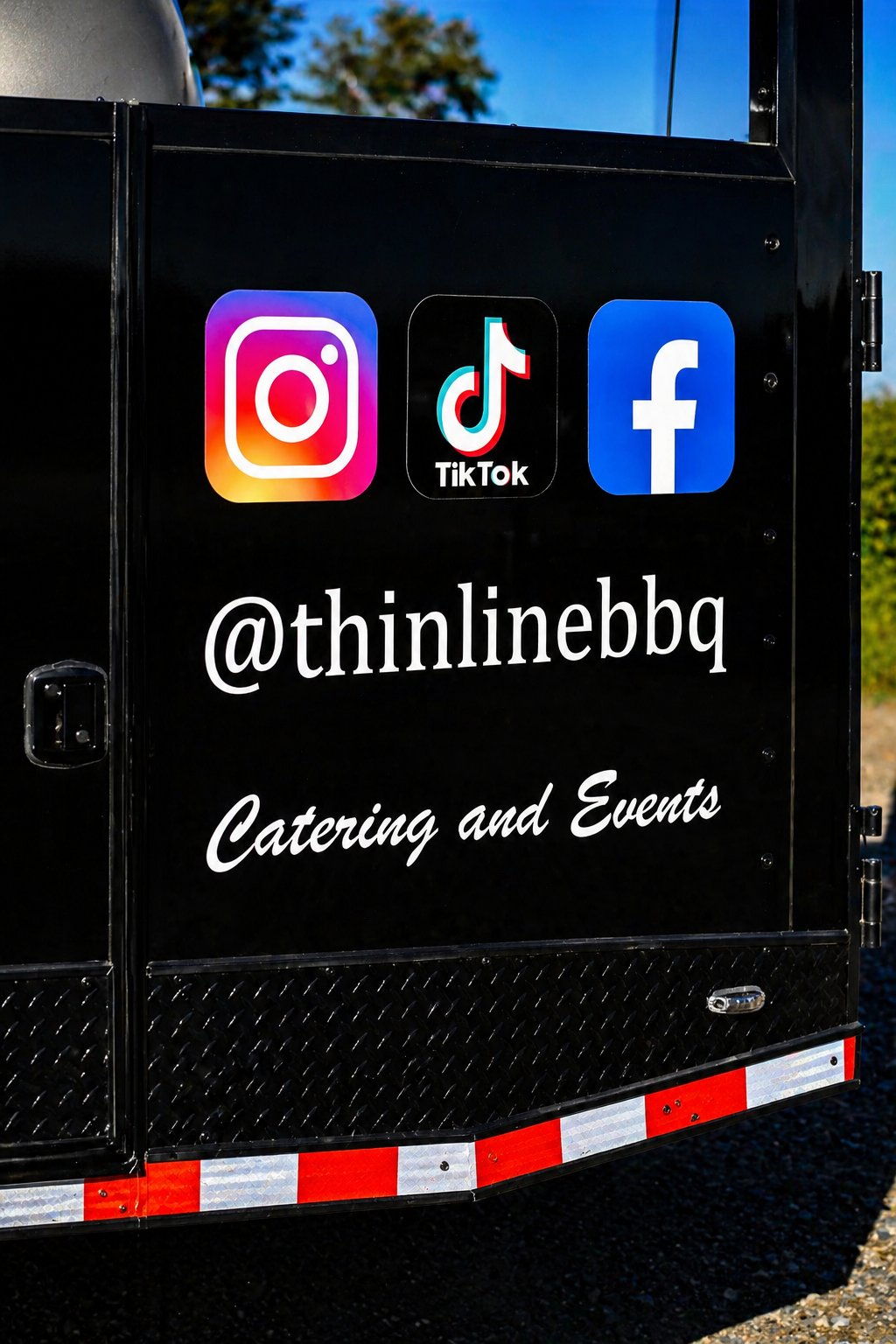 A black catering trailer displays social media icons for Instagram, TikTok, and Facebook, along with the handle '@thinlinebbq' and the text 'Catering and Events'.