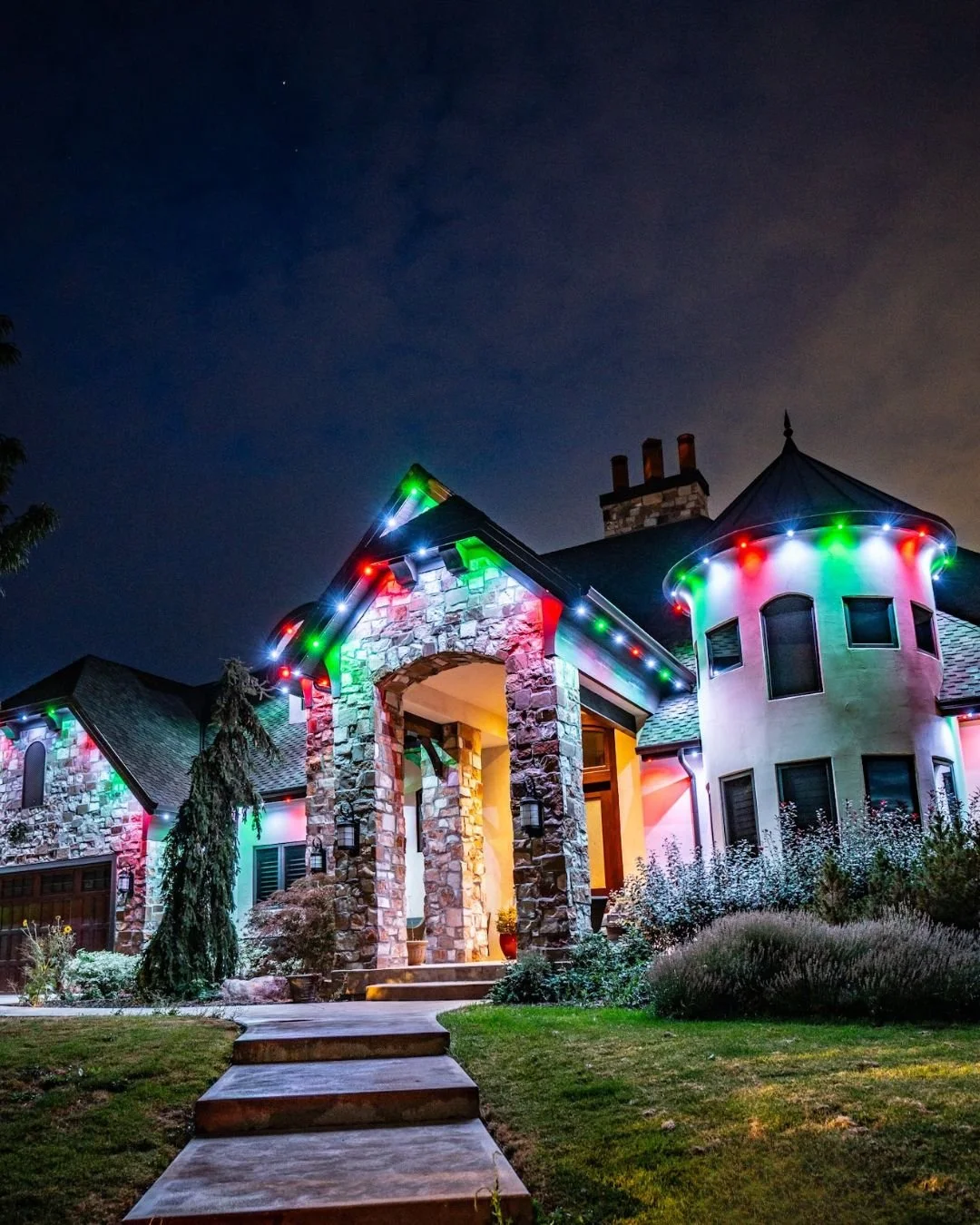 Custom red and green permanent Christmas light display installed along the roofline of a residential home in Granite Bay.