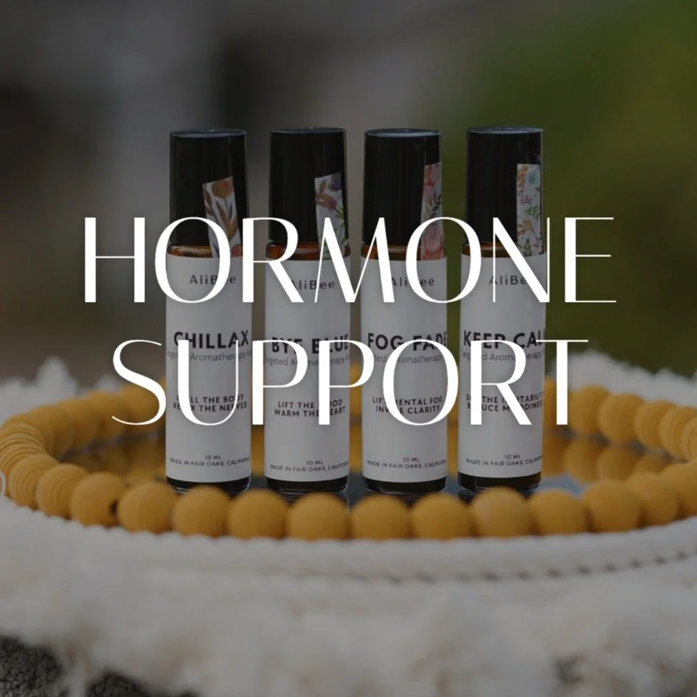 Four AliBee Hormone Support Aromatherapy Rollers, Chillax, Bye Blue, Fog Fade and Keep Calm, on a wooden bead garland