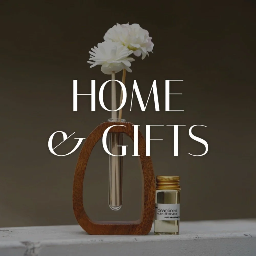 The Little Diffuser Set, a walnut arch reed diffuser with flower reeds and a small bottle of fragrance oil