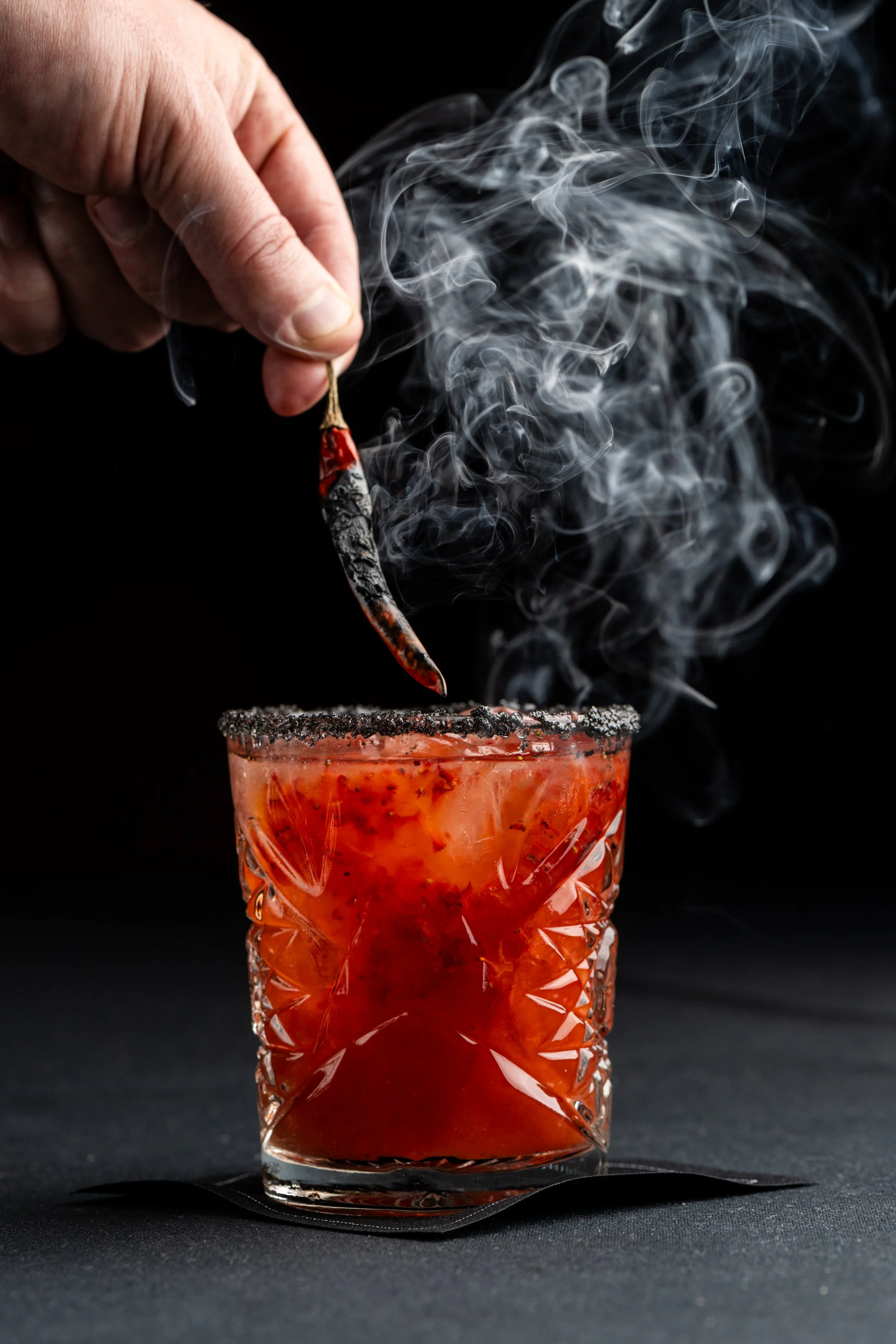 Kobe Bryant’s: BLACK MAMBA: Mezcal, Muddled Harry’s Berries Strawberries, Lime, Pasilla, Black Hawaiian Sea Salted Rim, Chile de Arbol