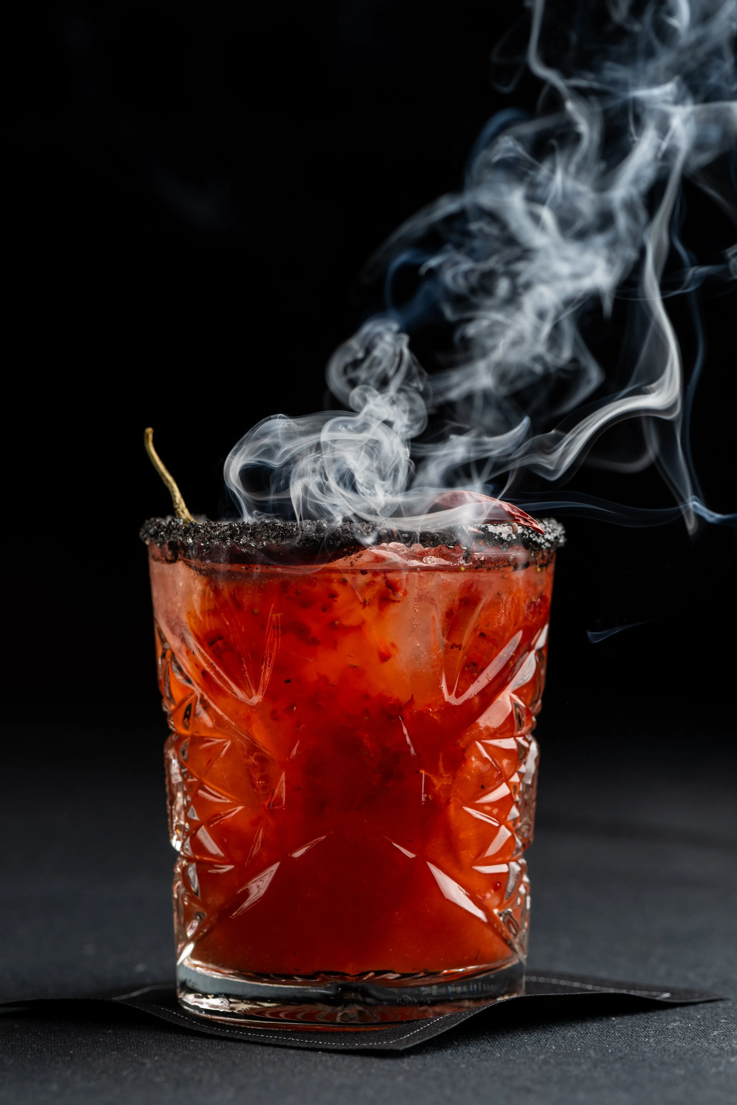 Kobe Bryant’s: BLACK MAMBA: Mezcal, Muddled Harry’s Berries Strawberries, Lime, Pasilla, Black Hawaiian Sea Salted Rim, Chile de Arbol