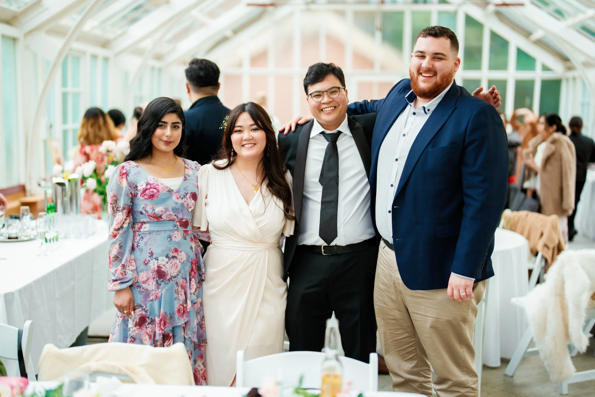 Bride and groom with wedding guests at Palm House reception, Sydney Botanic Garden