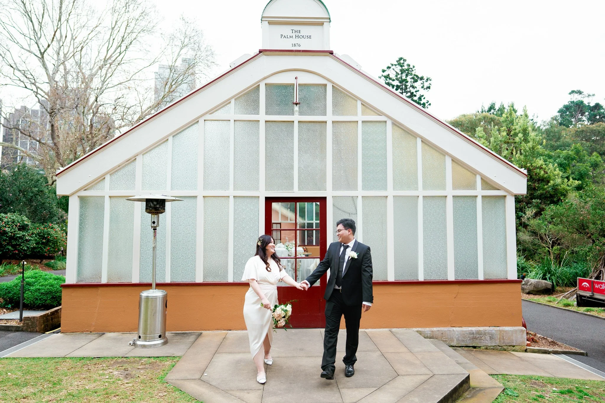 Bride and groom candid moment outside Palm House at Royal Botanic Garden Sydney