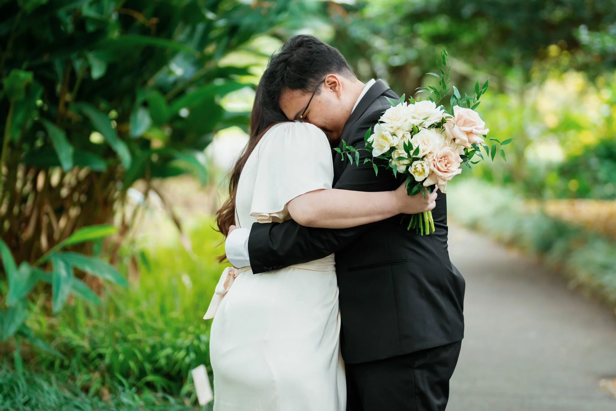 Candid Wedding Hug – Bride and Groom Embrace at Palm House Sydney Botanic Garden