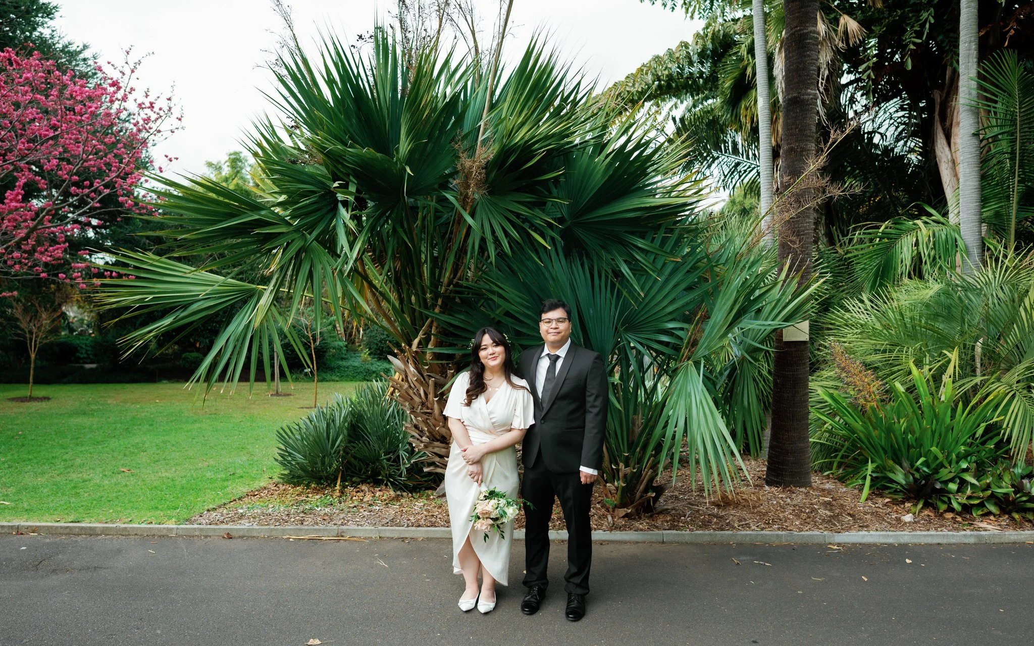 Hunter Valley wedding photographer – Candid couple portrait under cherry blossoms at Botanic Garden Sydney Palm House