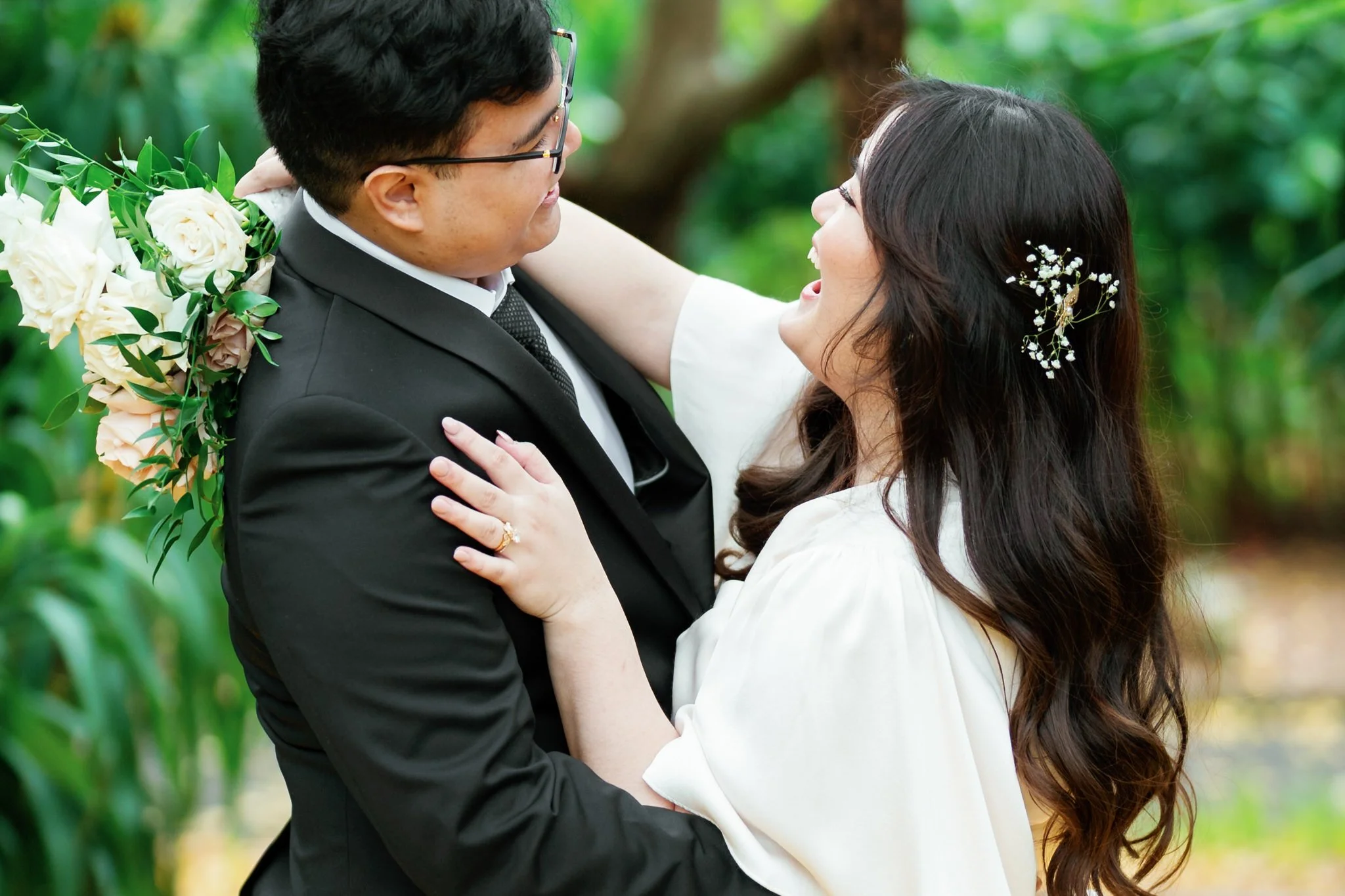 Bride and groom joyful embrace at Sydney Botanic Garden Palm House wedding reception