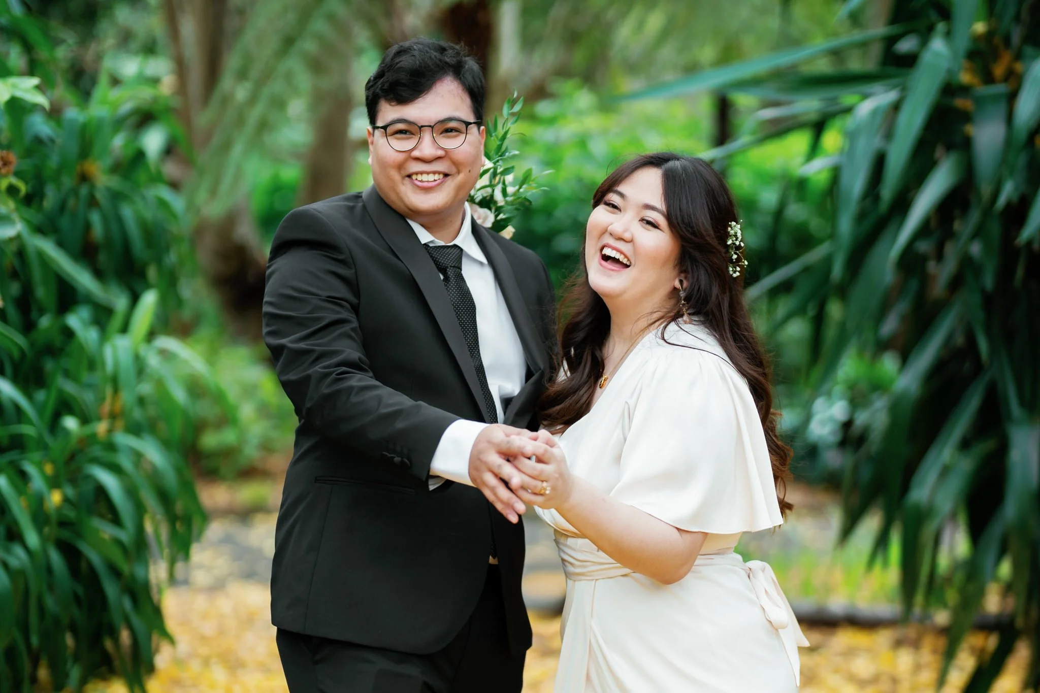 Laughing bride and groom portrait in lush gardens at Sydney Palm House wedding