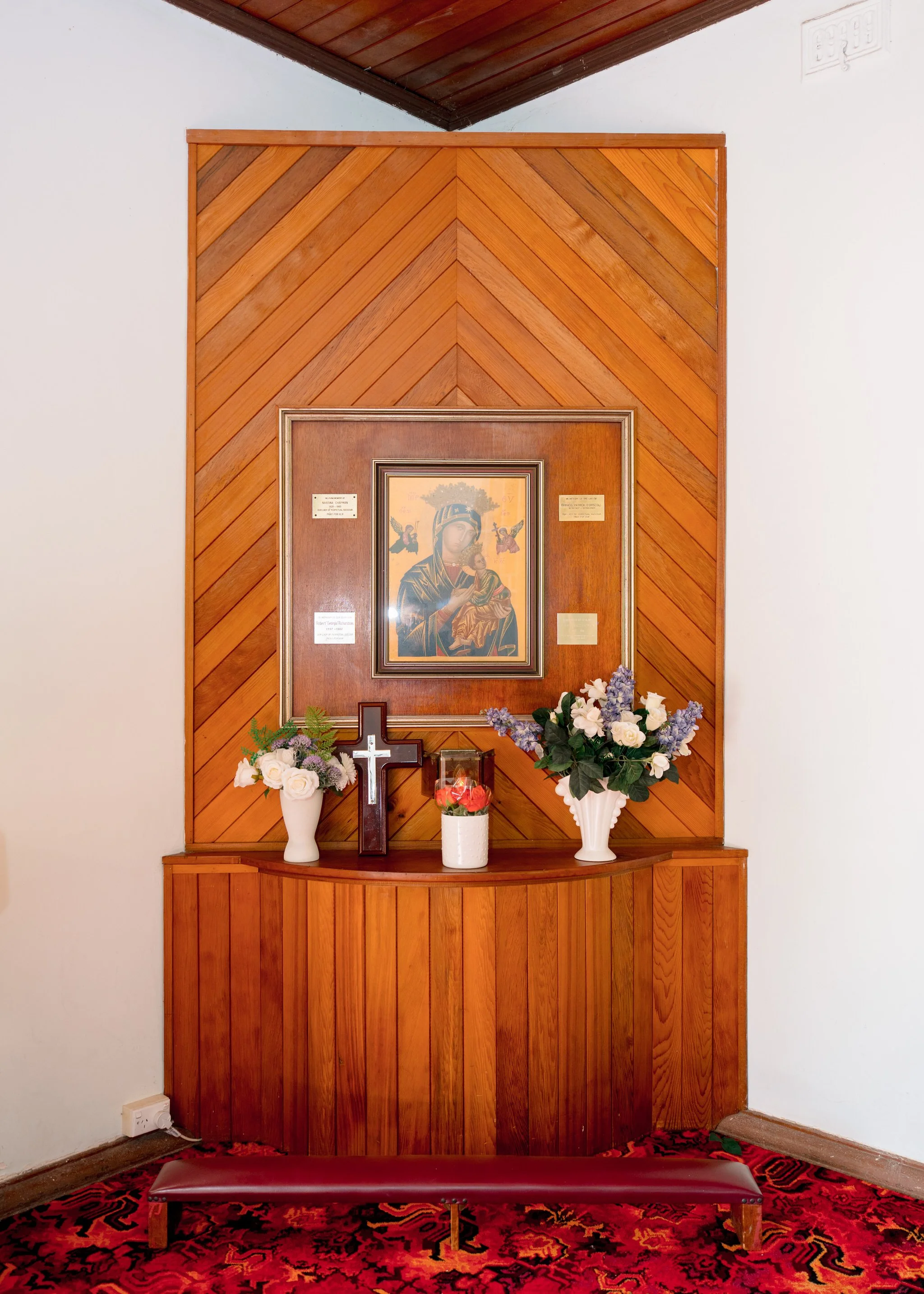 Religious icon and flowers displayed inside the church