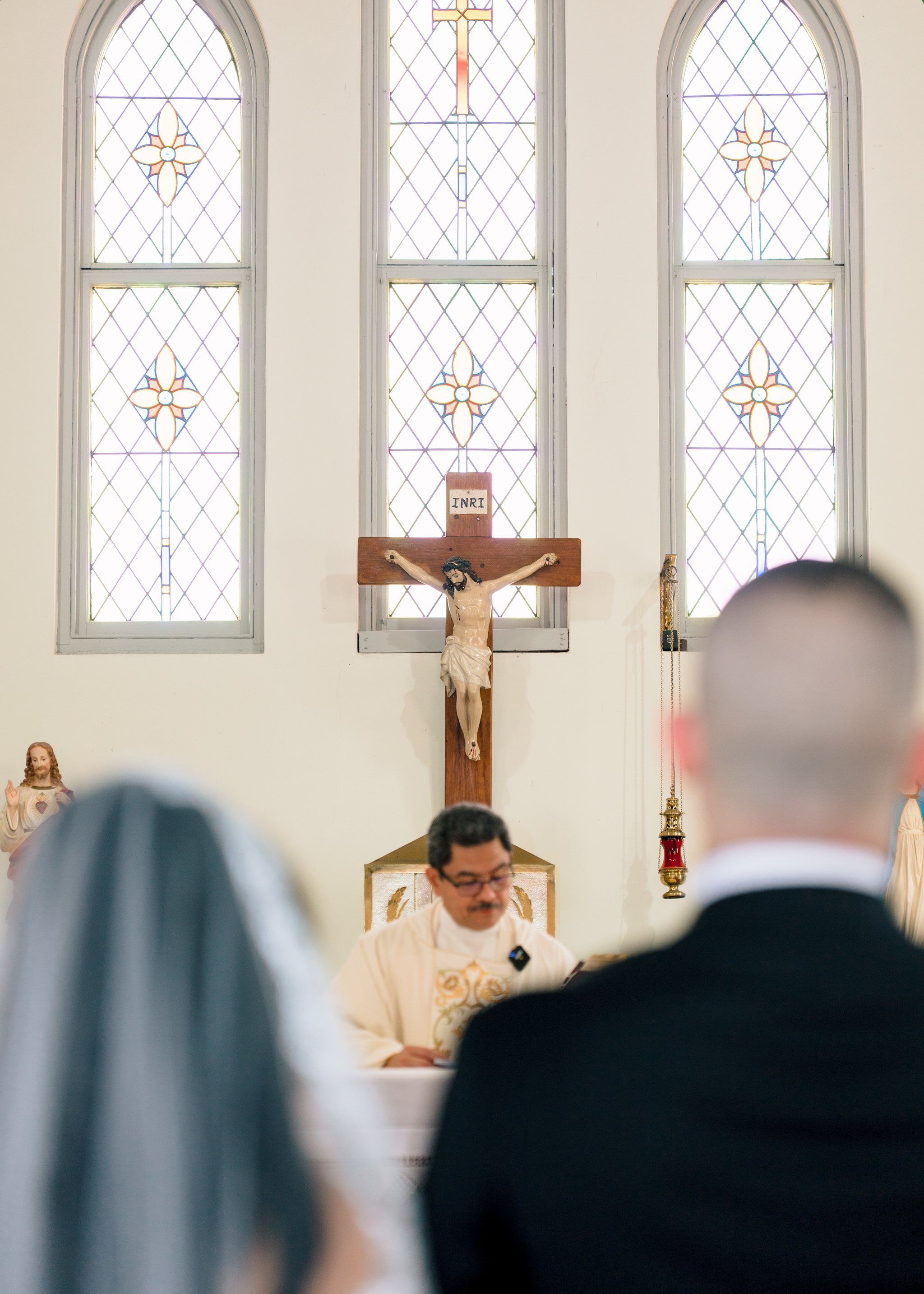 Crucifix and stained glass backdrop