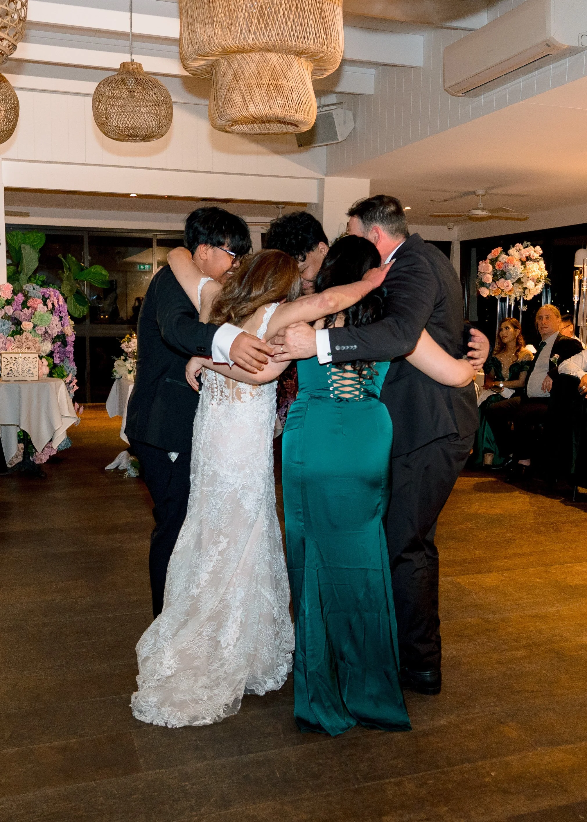 Wedding reception group hug Angelo’s Cabarita