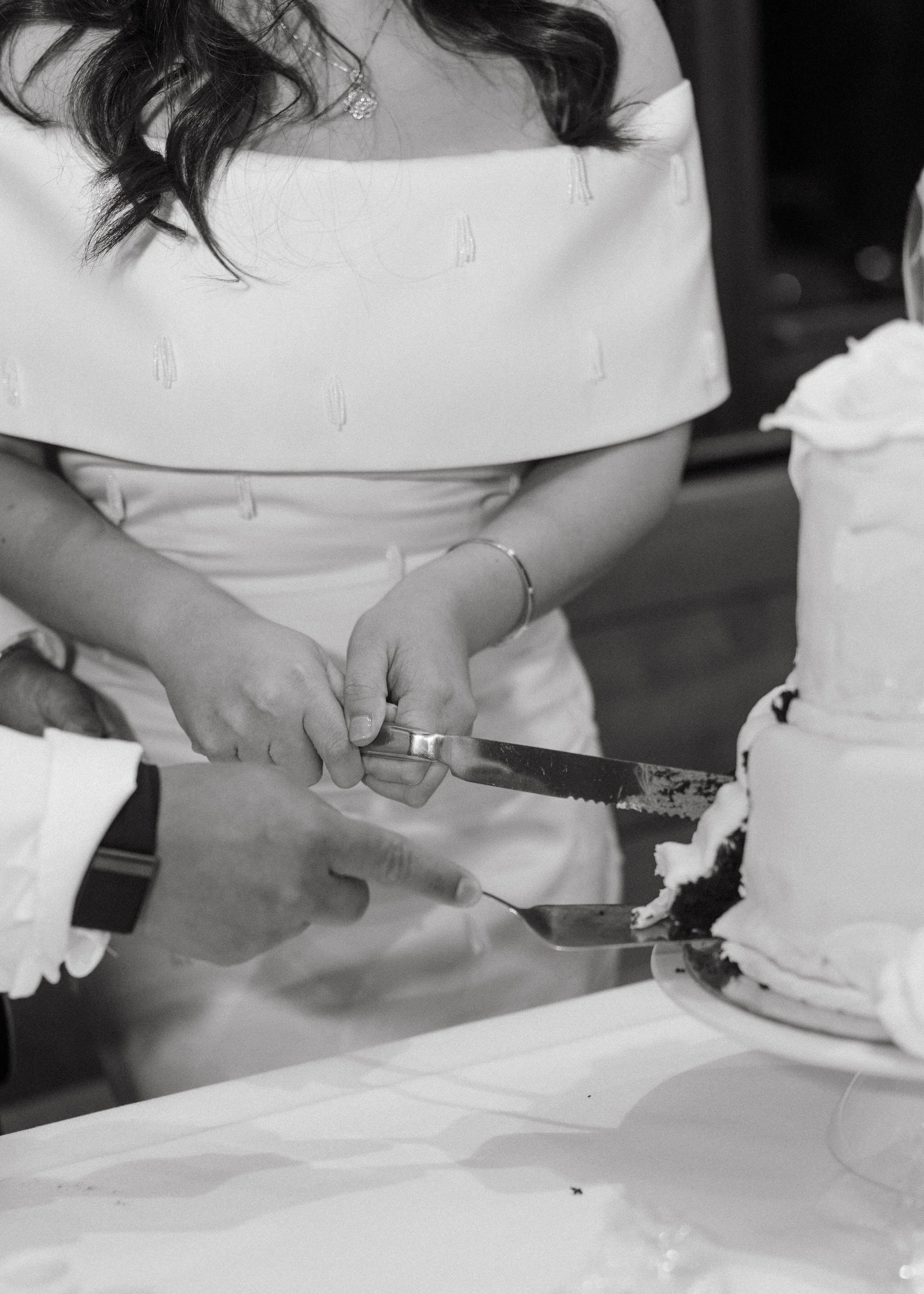 Black and white wedding cake cutting photo
