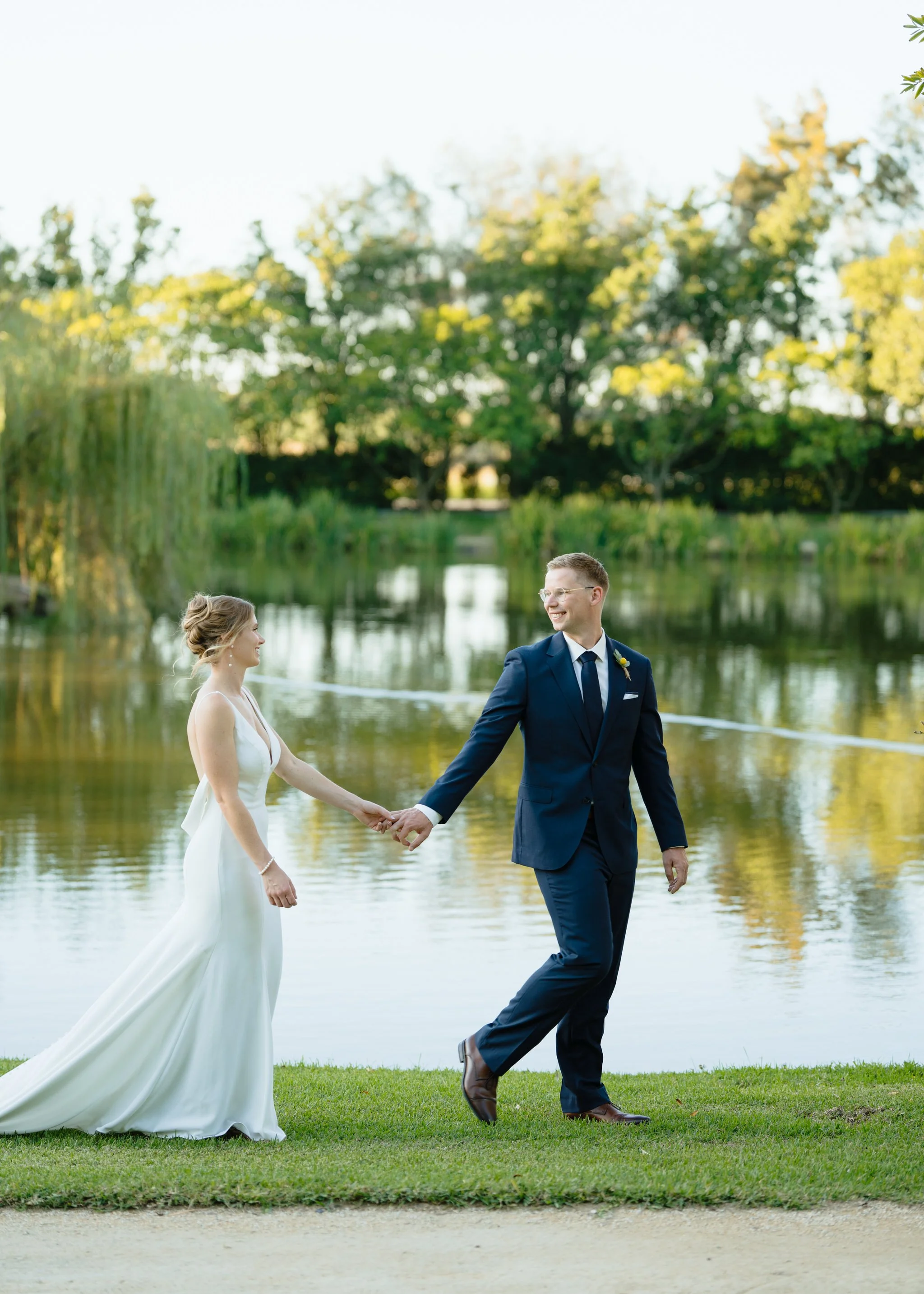 Couple walking lakeside Hunter Valley wedding portraits