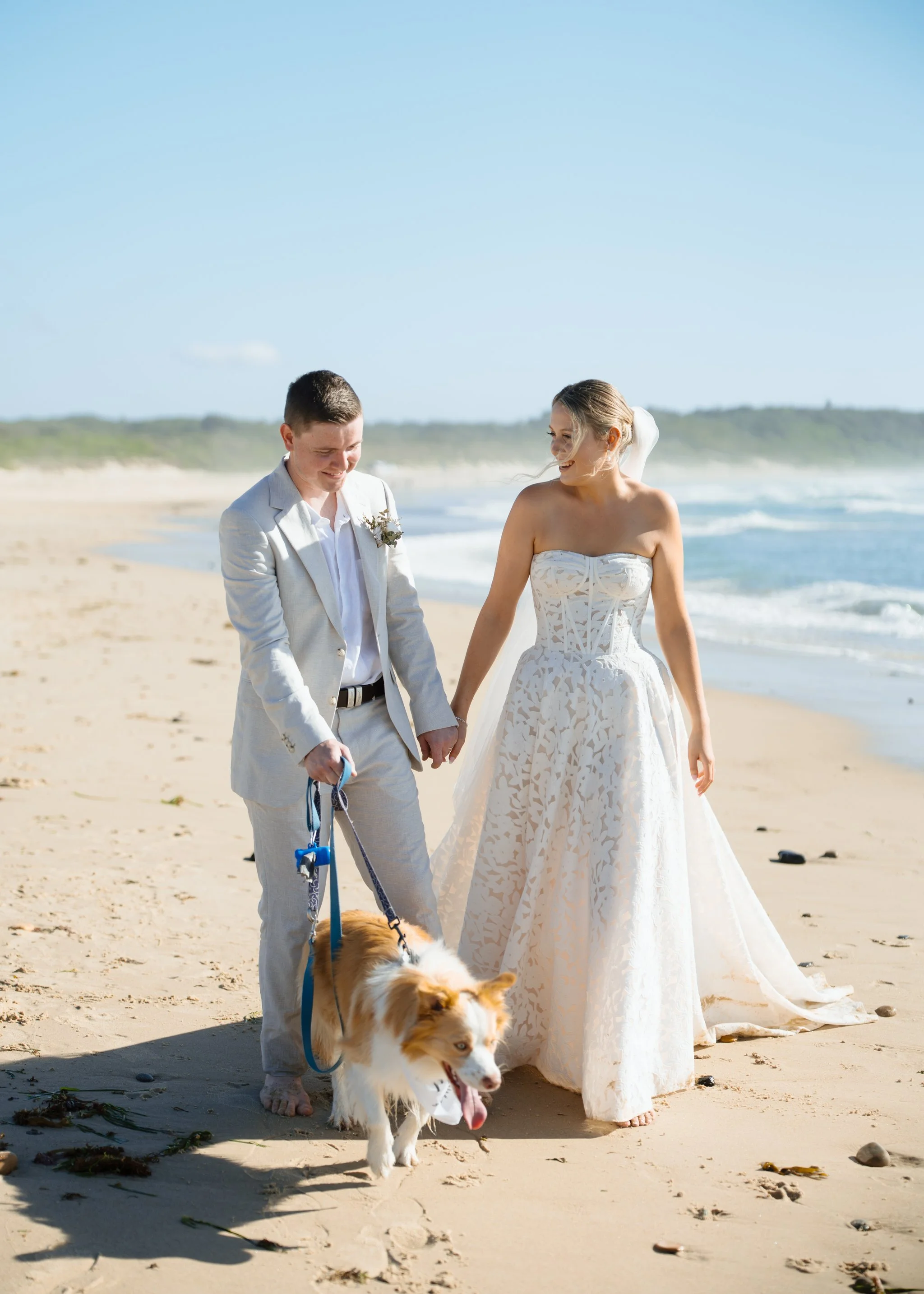 caves-beach-wedding-couple-walking-dog