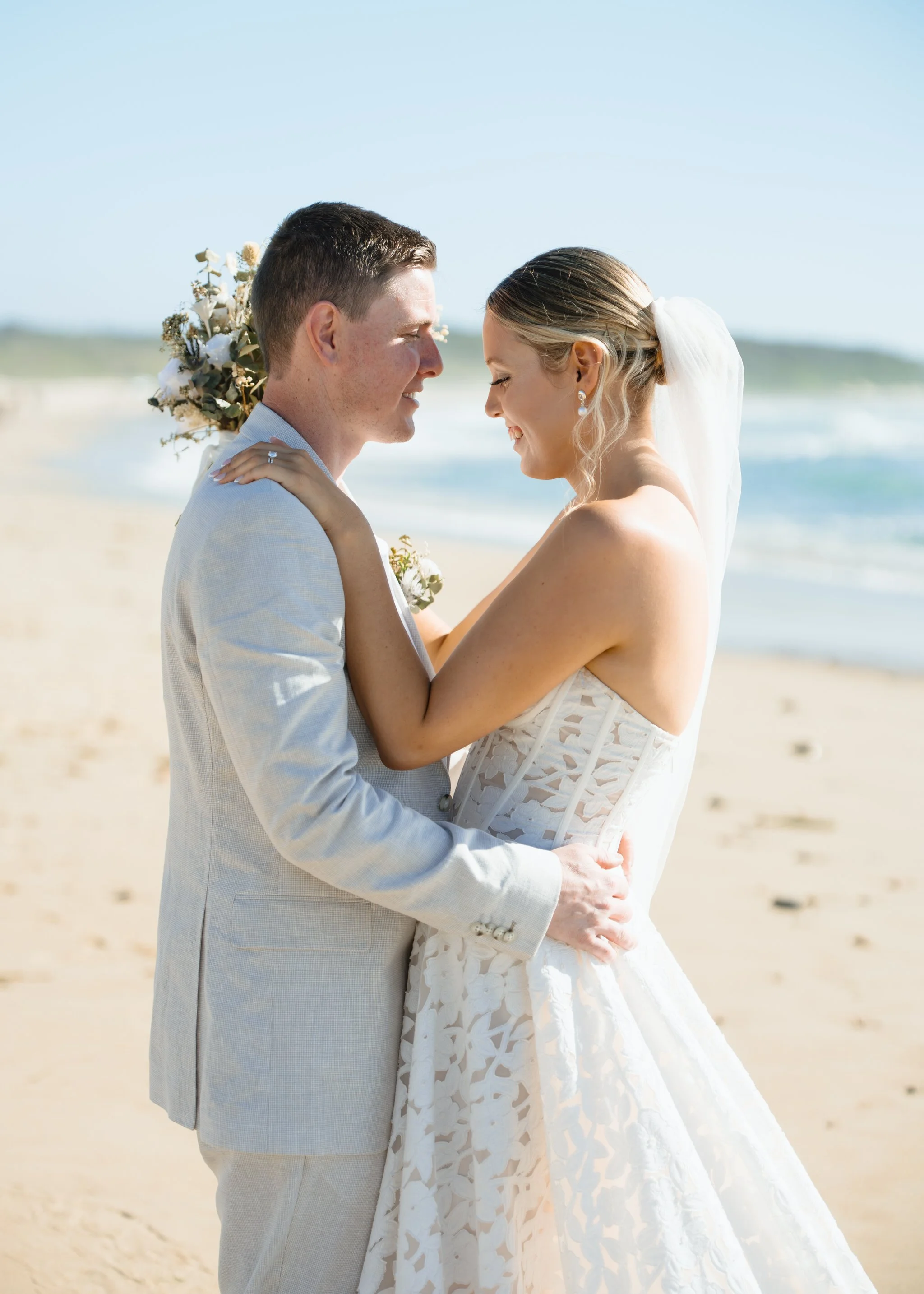 caves-beach-wedding-close-couple-embrace
