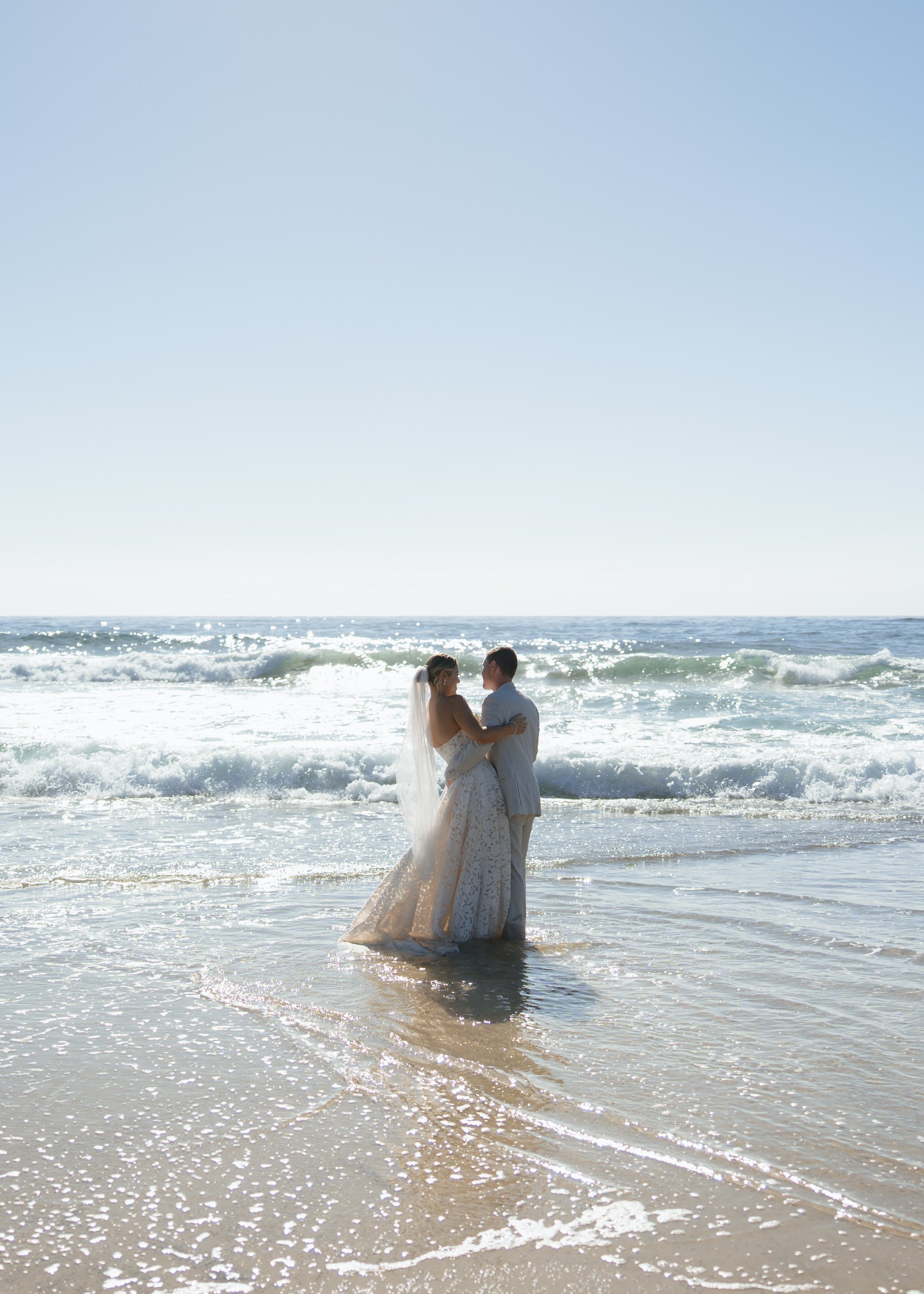 caves-beach-wedding-couple-water-embrace