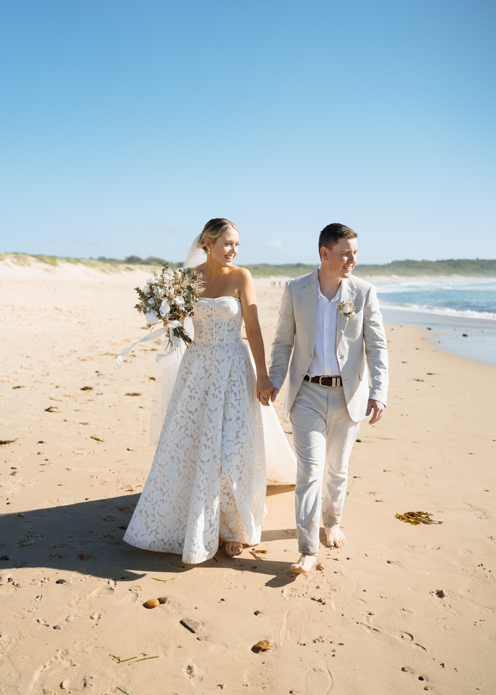 caves-beach-wedding-couple-walking-together