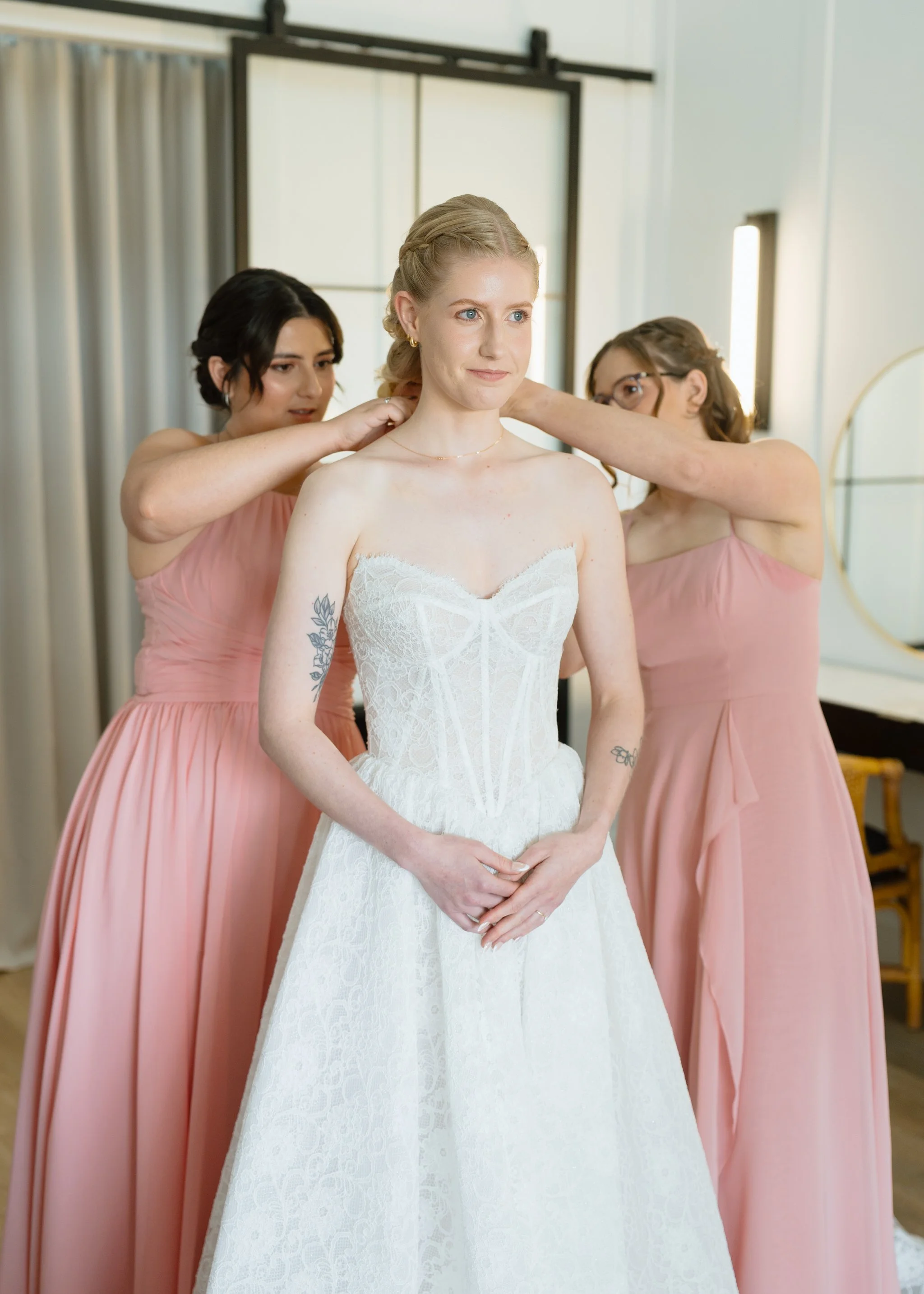 Bridesmaids Helping with the Bride's Necklace