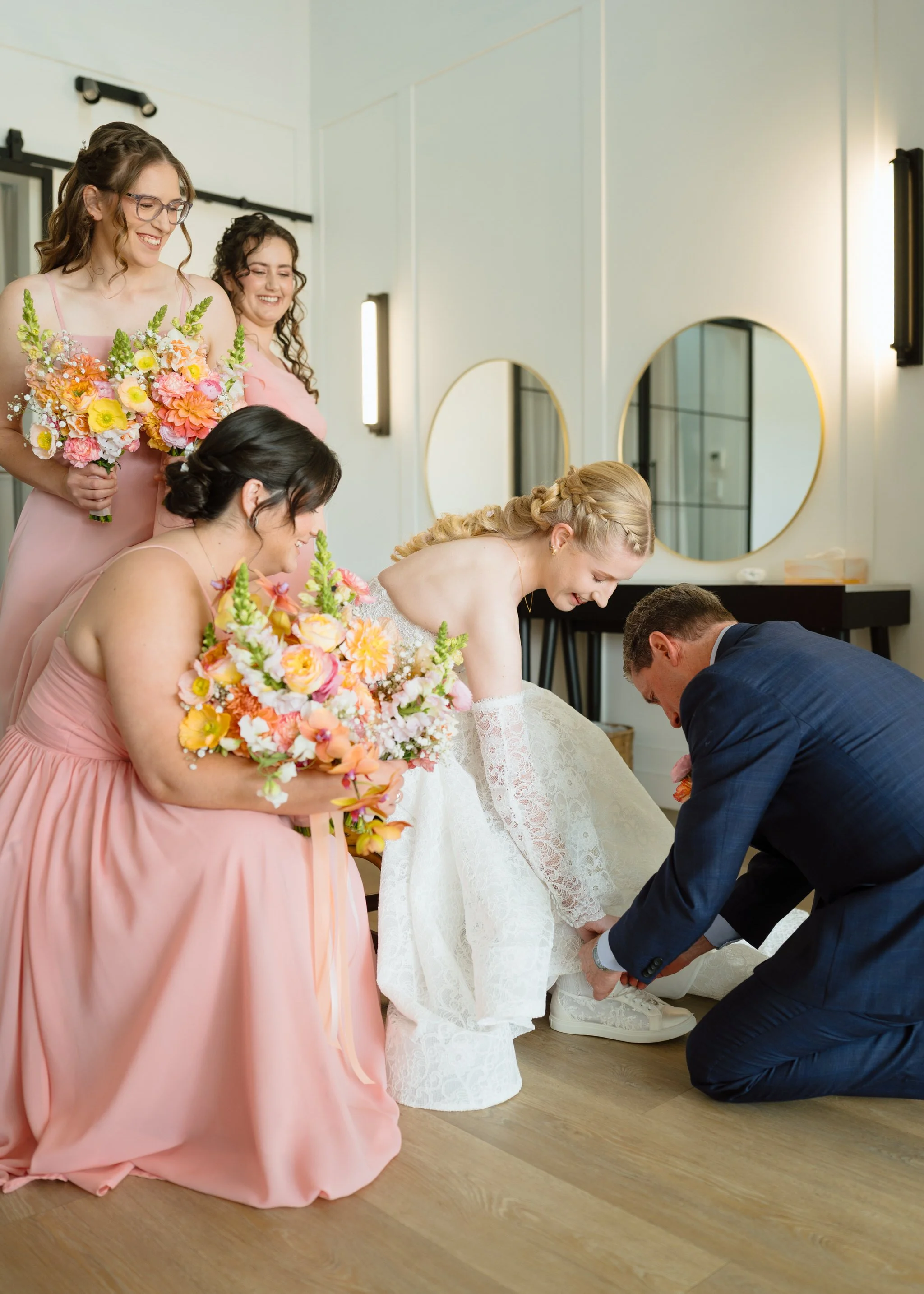 Helping the Bride with Her Wedding Shoes