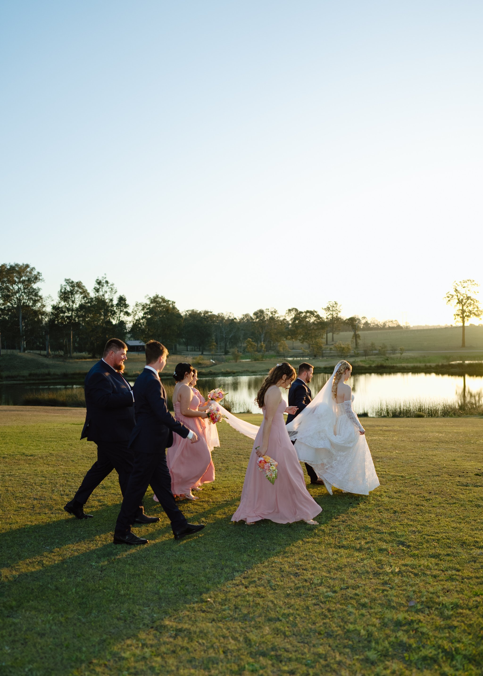 Wedding Party Walking Beside the Water at Squire's Vineyard